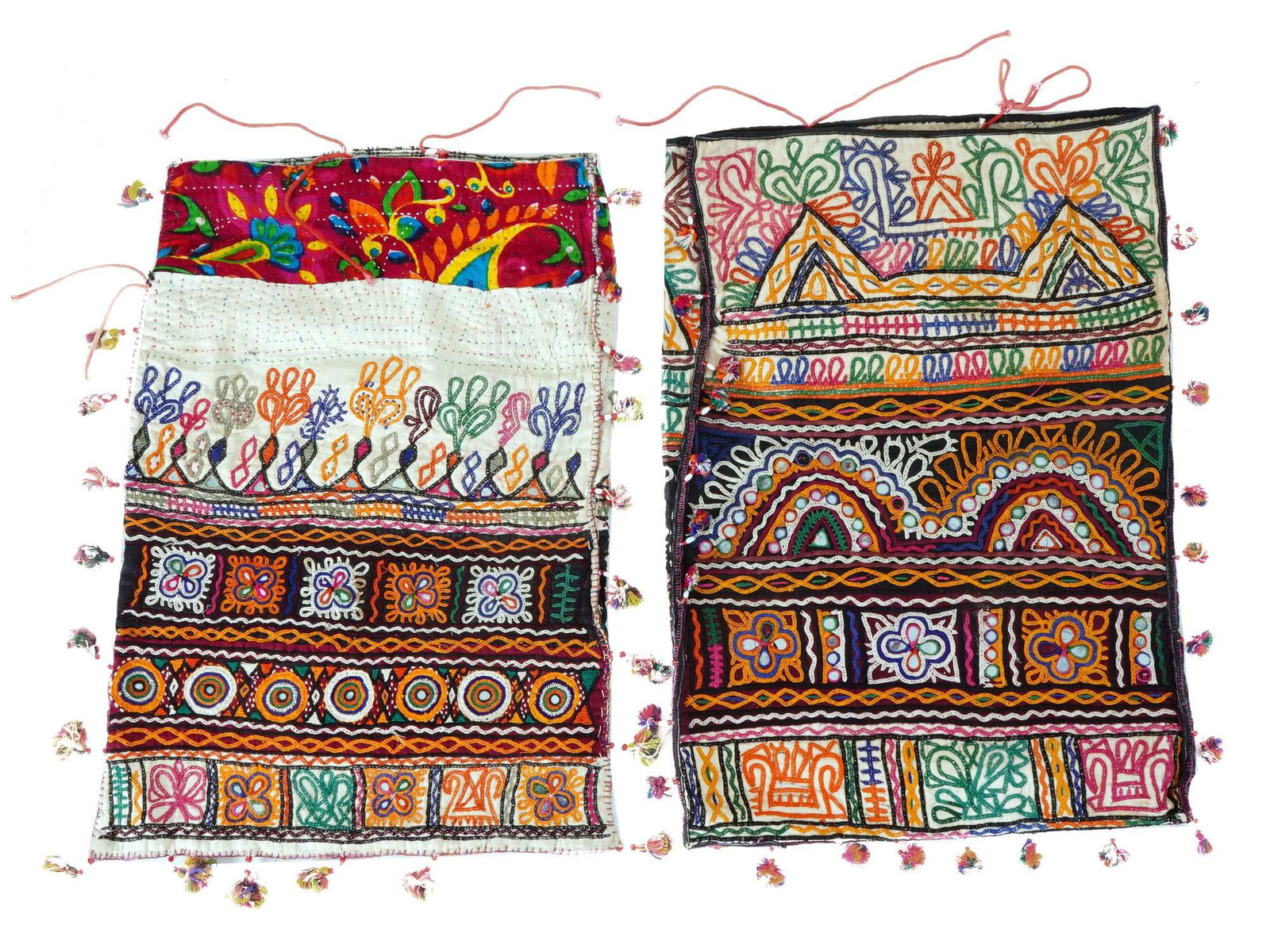 TWO VTG TEXTILE PILLOW CASES DOWRY BAGS: A lot of two vintage textile pillow cases or dowry bags, feature a rich array of embroidery, patchwork, and embellishments, displaying traditional geometric and floral motifs in vibrant colors and tri
