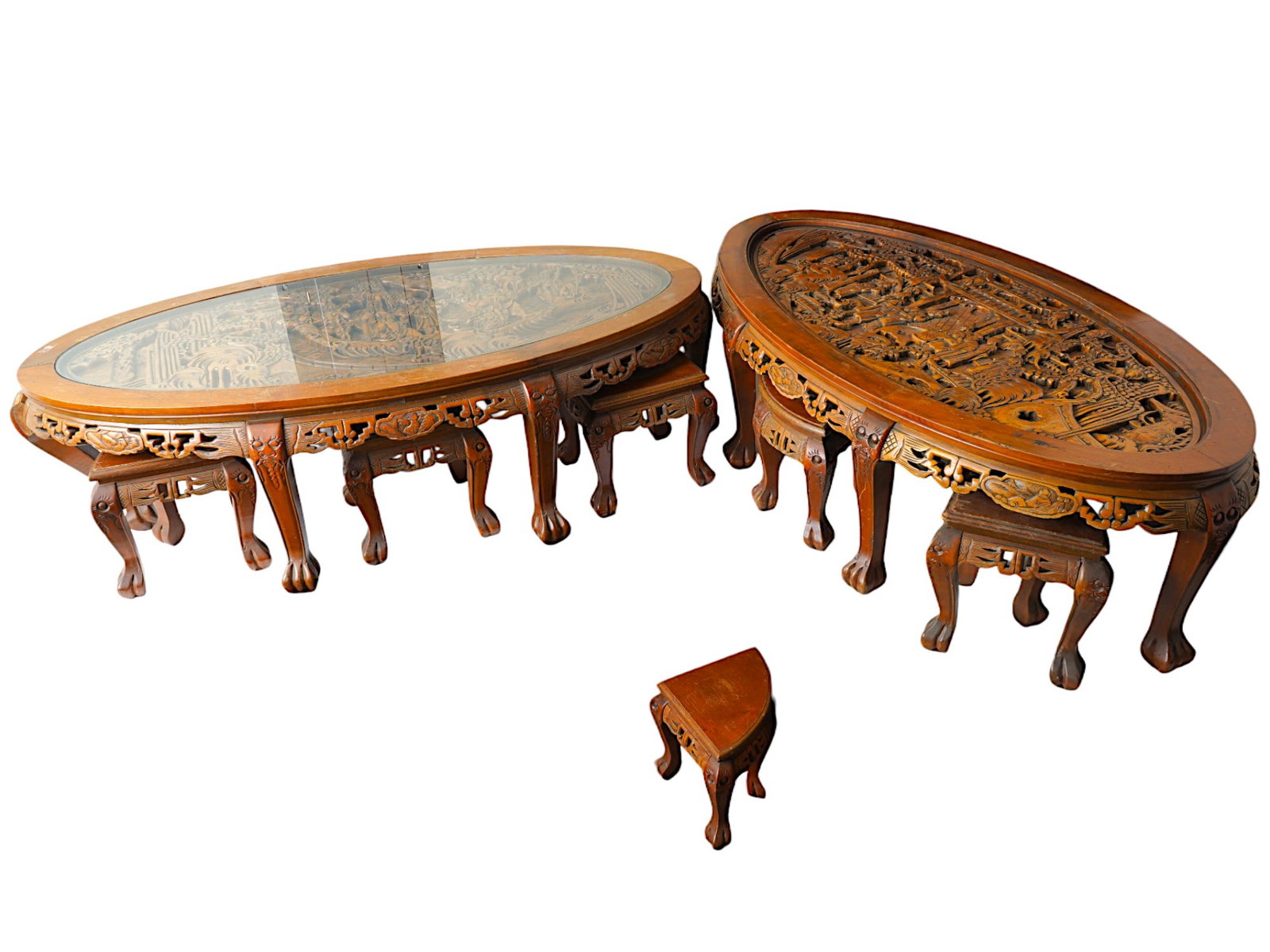 TWO CHINESE CARVED WOOD COFFEE TABLE CHAIR SETS: Two finely detailed Chinese carved wood coffee table sets. Circa mid to late 20th century. The lot includes two massive oval tables richly decorated with beautifully detailed genre scenes of palace li