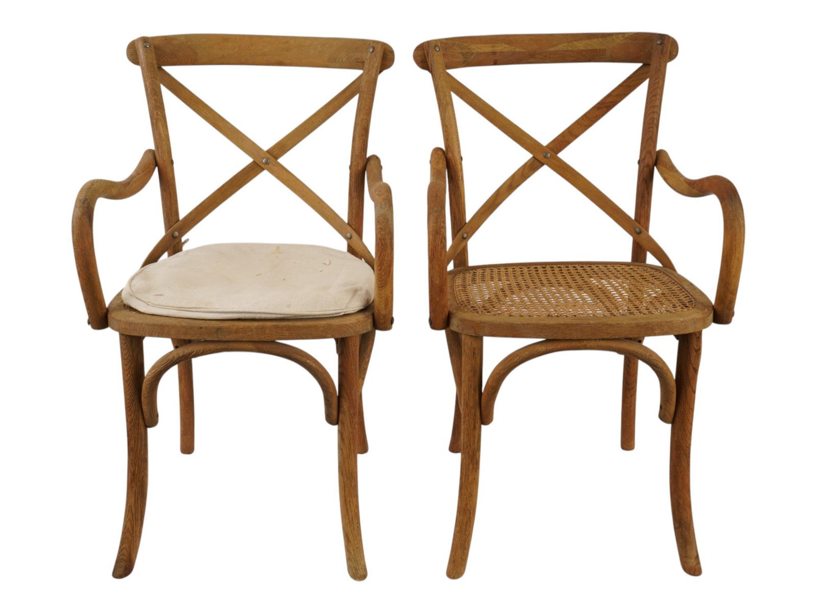 TWO VINTAGE CLASSIC WOODEN RATTAN CROSS ARMCHAIRS: A lot of two vintage classic wooden Cross Armchairs. Cira, mid to late 20th century. The Viennese-style chairs are made of durable solid wood with a woven rattan seat. European Furniture for Garden, H