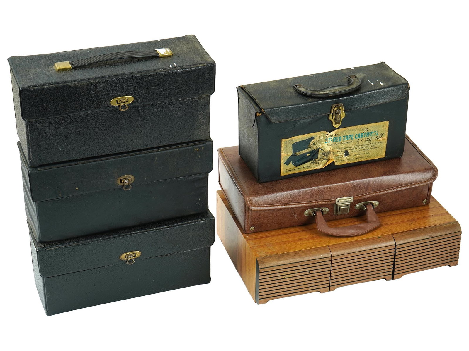 VINTAGE 8 TRACK STEREO TAPE CARTRIDGES AUDIO CASSETTES: A collection of mixed vintage 8-track stereo tape cartridges and audio cassettes from the 1970s and 1980s, stored in four cases, a suitcase, and a wooden box. These classic formats capture the music a