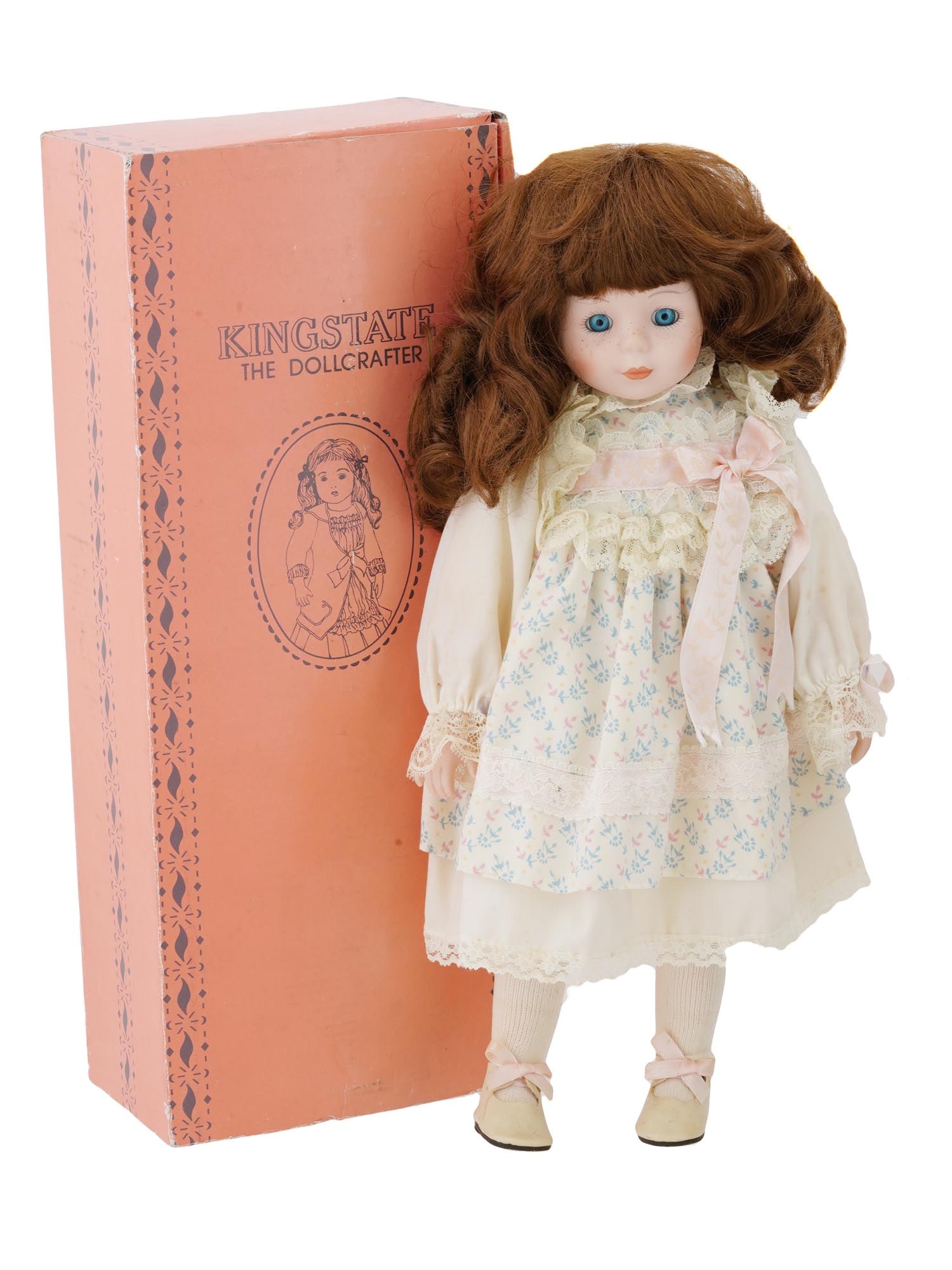 VTG PRINCESS HOUSE JENNIFER PORCELAIN DOLL 1991: A vintage porcelain doll Jennifer by Princess House, copyrighted in 1991. The doll has reddish-brown curly hair and blue eyes with lashes. She wears a beautiful cream dress with printed flowers, decor