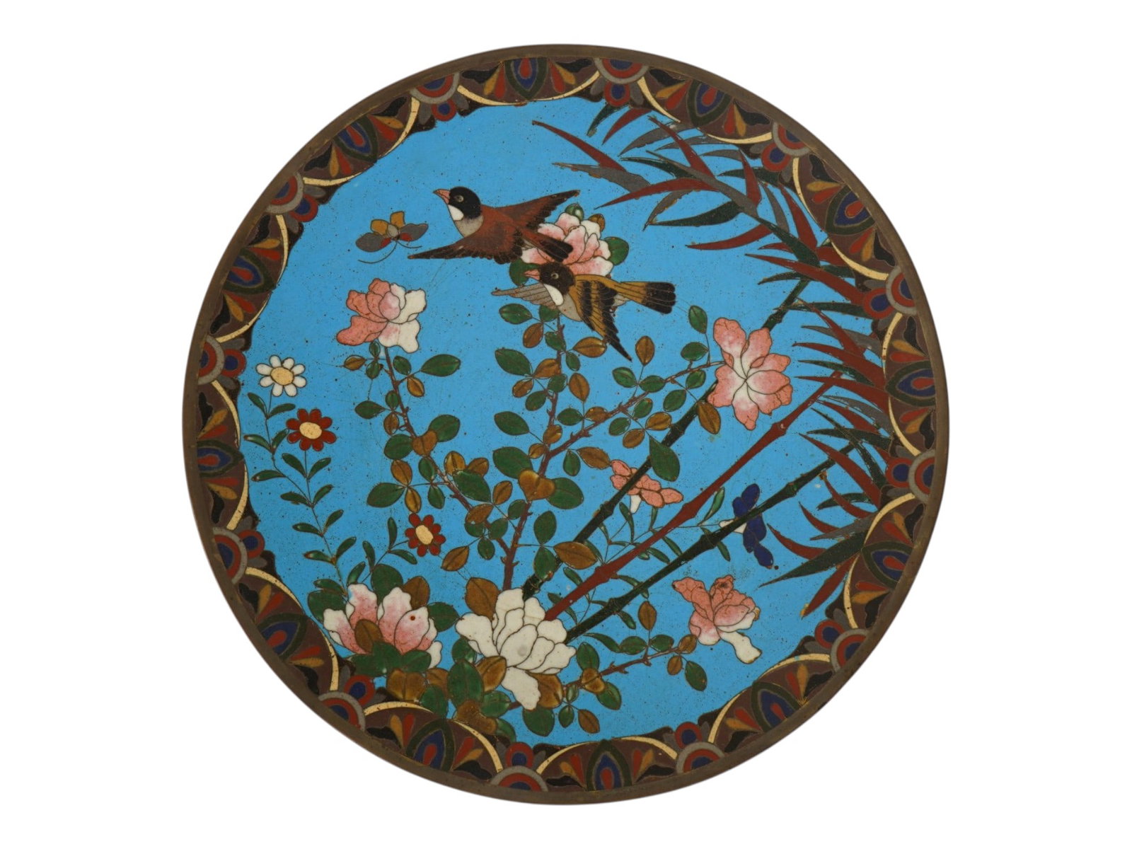 JAPANESE POLYCHROME DESIGN CLOISONNE ENAMEL PLATE: A Japanese decorative enamel over copper plate or charger. The interior of the plate is adorned with a polychrome design of a pair of sparrows and a butterfly in blossoming flowers and plants on the t