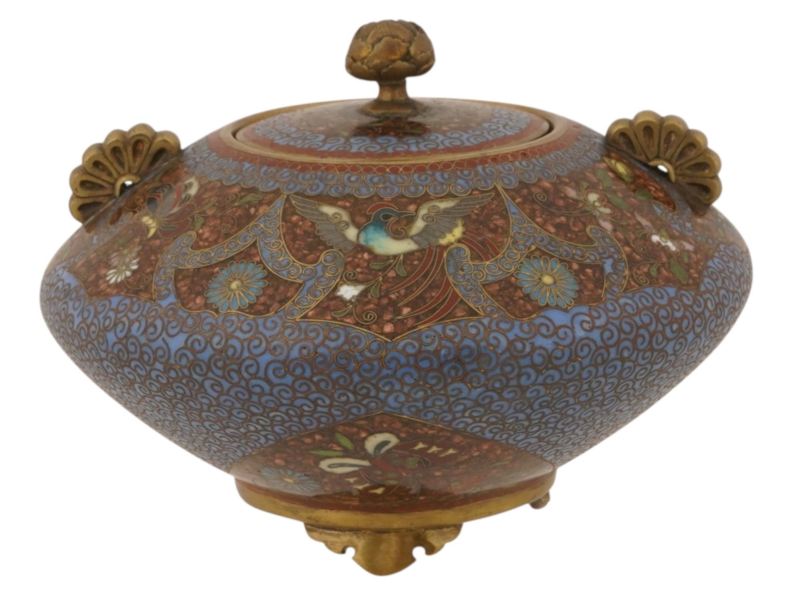 ANTIQUE JAPANESE MEIJI ENAMEL LIDDED CENSER KORO: An antique Japanese cloisonne enamel lidded censer koro from the Meiji period. The tripod-form vessel is decorated with a phoenix, scrolling floral motifs, and intricate blue karakusa enamel, and is f