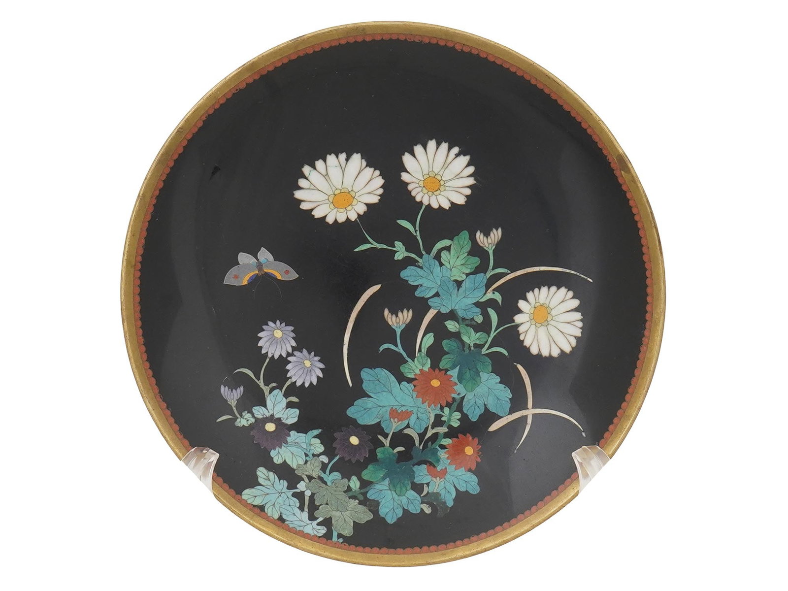VINTAGE CHINESE CLOISONNE FLOR BUTTERFLY PLATE CHARGER: A vintage Chinese cloisonne plate charger decorated with a colorful flower and butterfly design at the center, on a black ground. The rim features a delicate beaded edge, showcasing traditional crafts