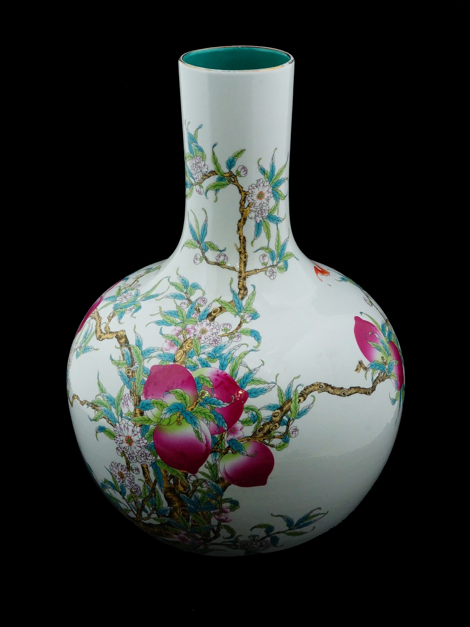 ANTIQUE CHINESE QING FAMILLE ROSE PORCELAIN VASE: An antique Chinese Late Qing Dynasty Famille Rose porcelain bottle vase. The globular shaped vase with a long neck is adorned with a polychrome painting design representing branches with peaches and b
