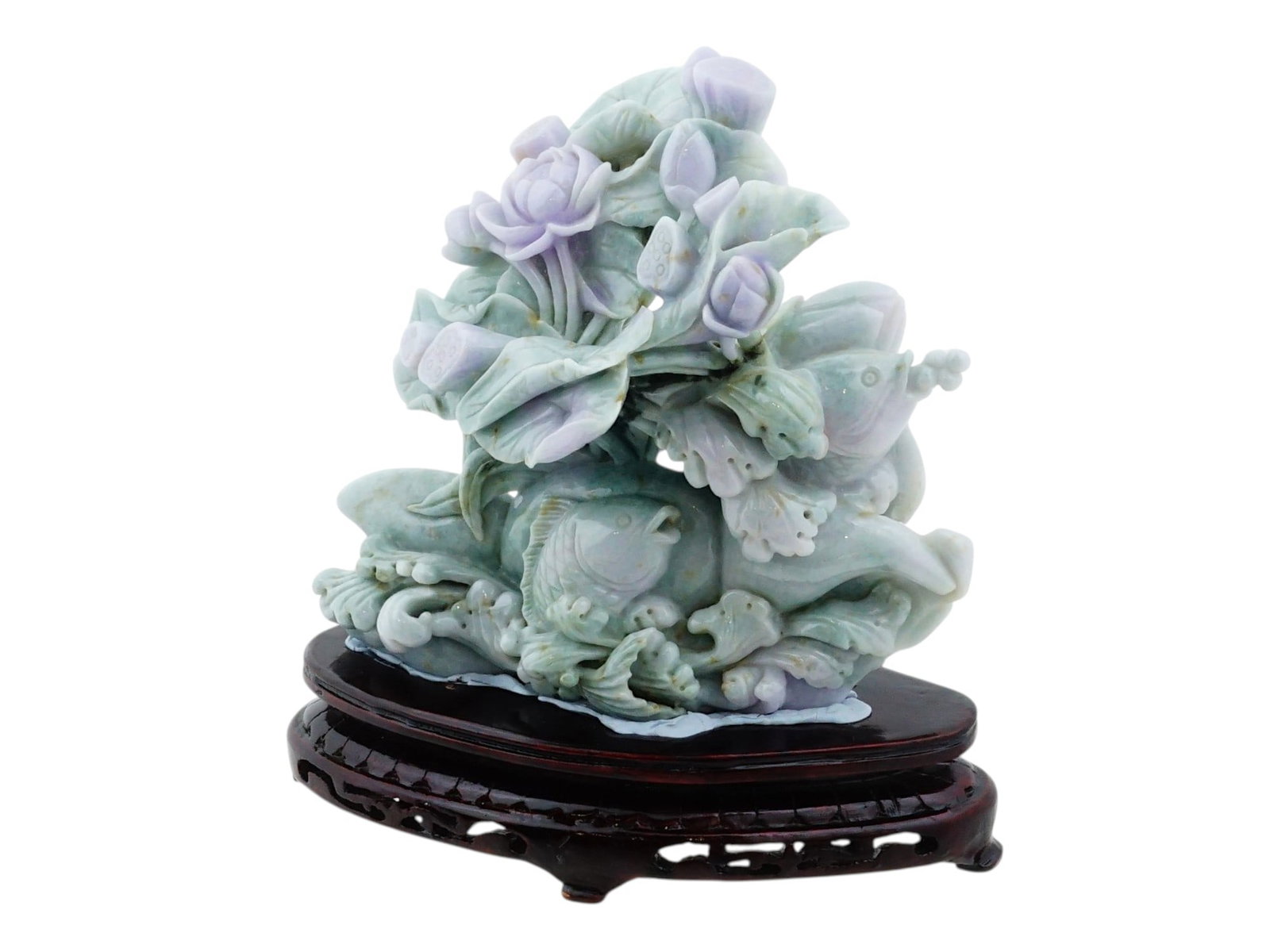 VINTAGE CHINESE HAND CARVED NATURAL JADEITE SCULPTURE: A vintage Chinese hand-carved natural jadeite sculpture depicting lotus blossoms and fish, carved from a single multi-colored jadeite boulder and presented on a custom openwork hardwood stand. The car
