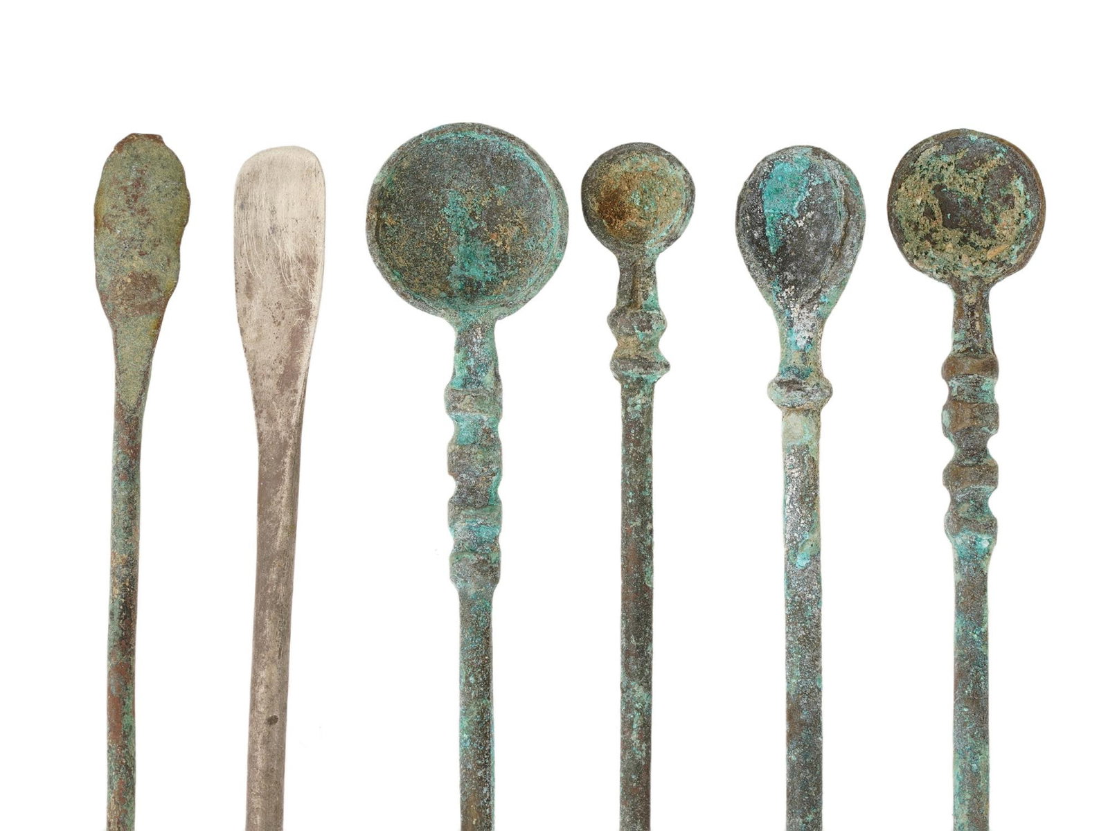LOT ANCIENT ROMAN BRONZE SILVER MEDICAL COSMETIC TOOLS: A group of ancient Roman silver and bronze medical and cosmetic tools, features spoons and spatulas in various sizes and shapes. Circa 100 to 300 AD. These tools, crafted with precision and expertise,