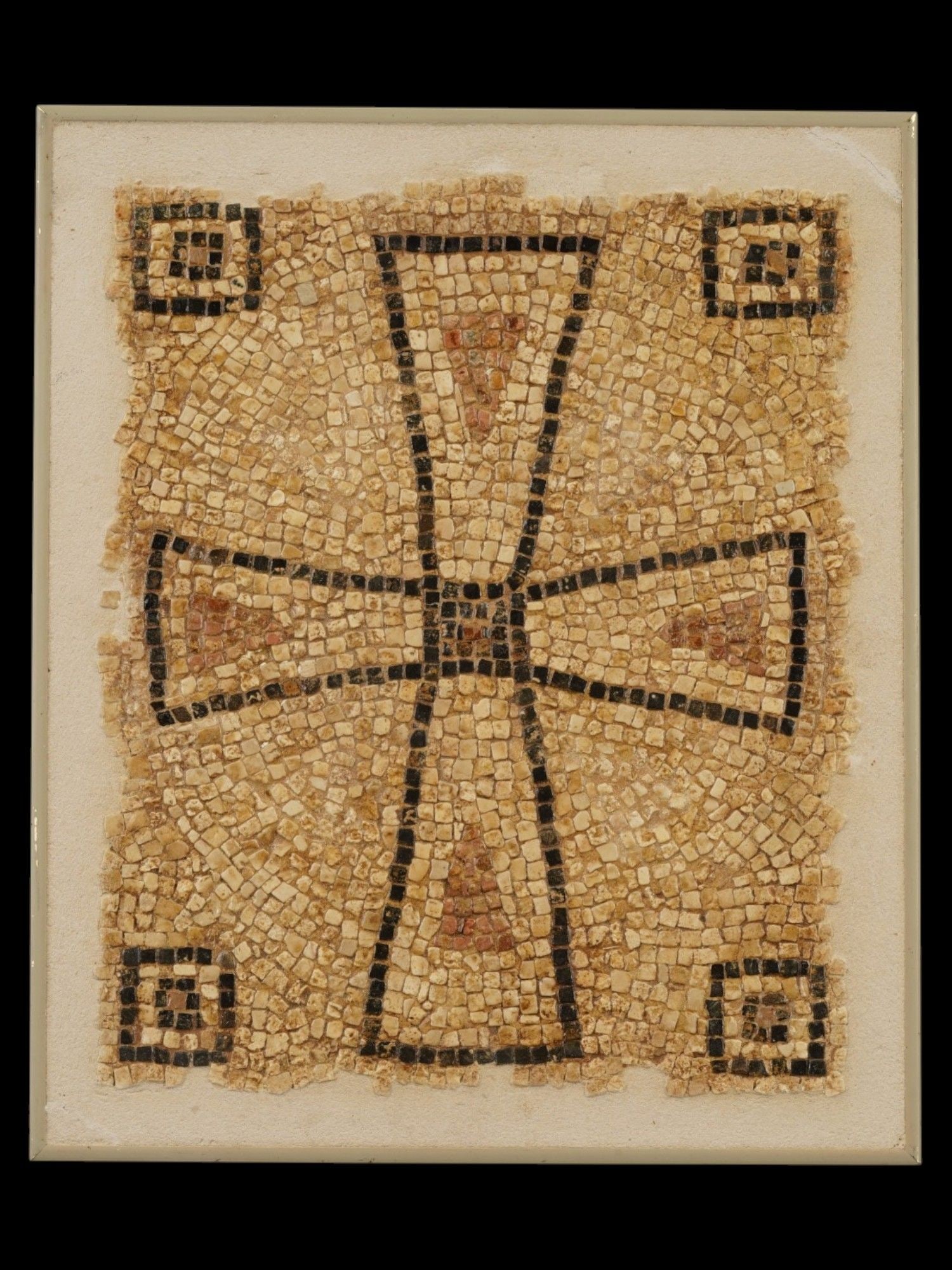 ANCIENT BYZANTINE MOSAIC OF CROSS 400 TO 600 AD: An ancient Roman mosaic artwork composed of tesserae pieces dating circa 400 to 600 AD. The mosaic depicts a cross. The composition is bordered by four corner squares containing stylized motifs charac