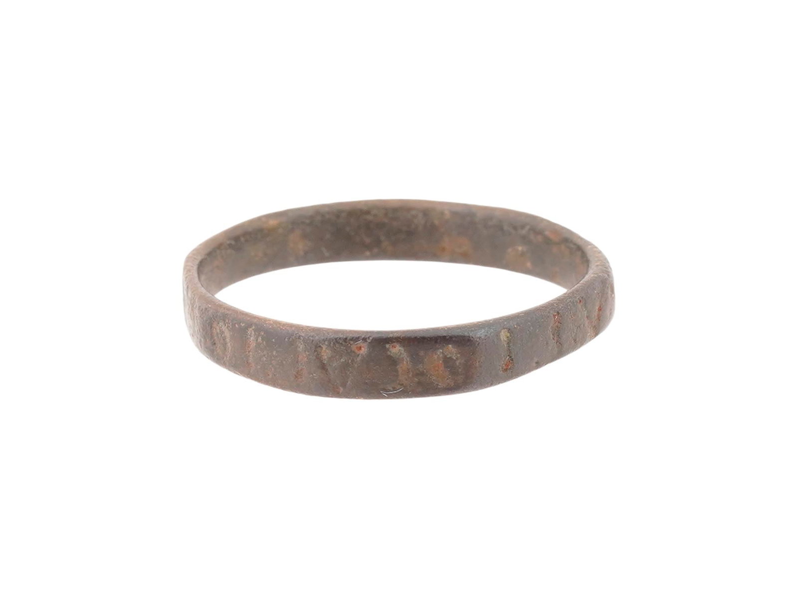 ANCIENT ROMAN BRONZE INSCRIBED RING 100 TO 300 AD: An ancient Roman bronze ring, dating circa 100 to 300 AD, features a continuous flat band design. The exterior surface is decorated with an incised epigraphic inscription, likely representing a protec