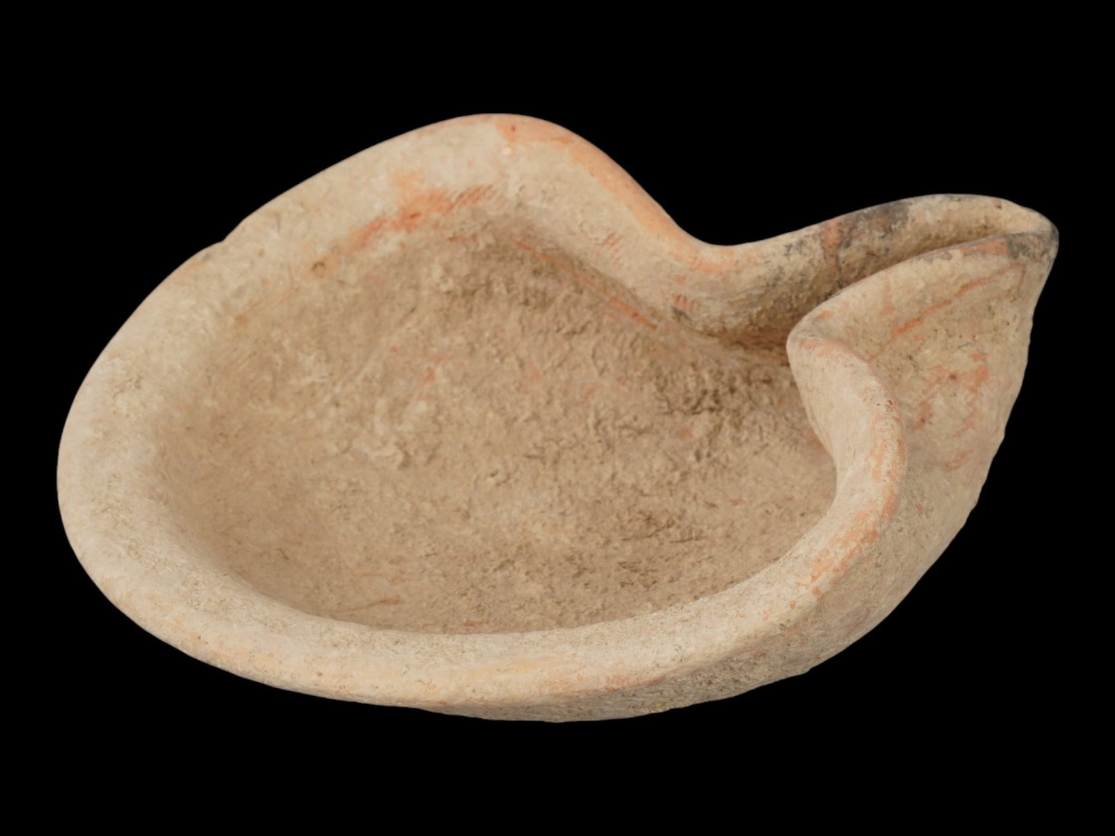 ANCIENT HOLY LAND JUDAICA TERRACOTTA SAUCER: An ancient Middle Eastern Judaica terracotta saucer from the Holy Land, ca. 1000 to 800 BC. The piece is shaped like an oil lamp with a distinct, narrow spout. It has a wide, outward-curving rim and a