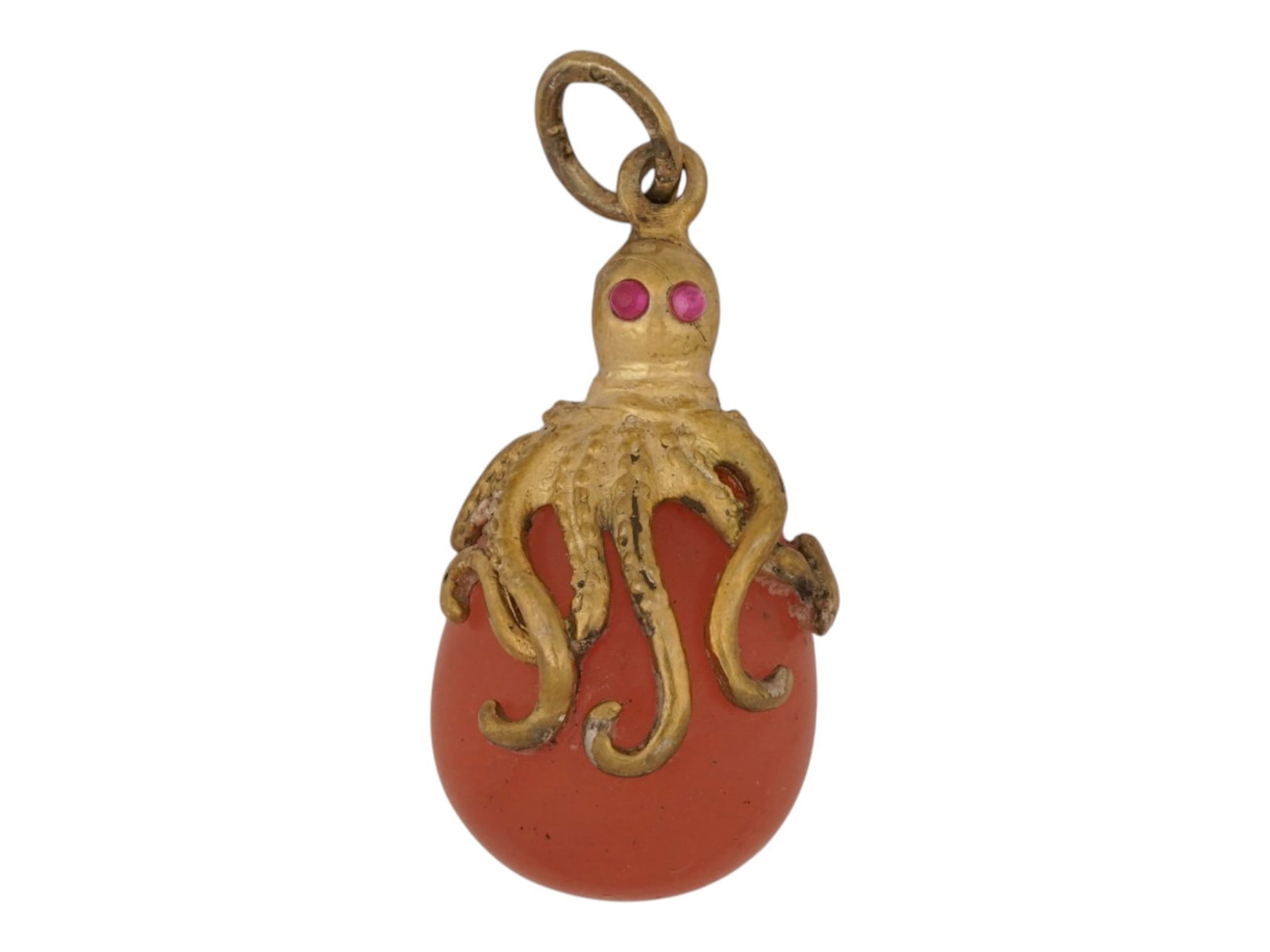 RUSSIAN SILVER AND ROSE QUARTZ EASTER EGG PENDANT: A Russian carved rose quartz Easter Egg pendant. Topped with a figural gilt silver octopus with ruby eyes. Hallmark of 84 silver standard and makers mark are on the fitting ring. Total Weight: 12 g.