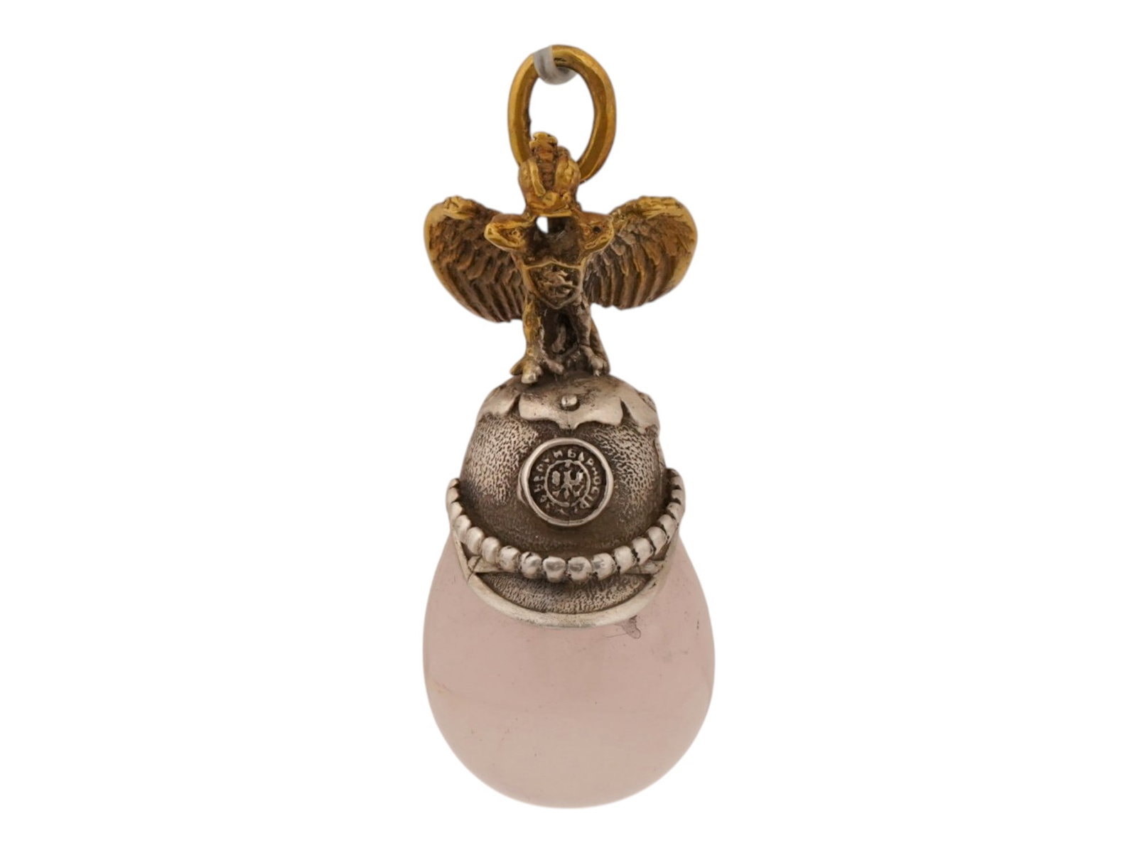 RUSSIAN SILVER ROSE QUARTZ HELMET EASTER EGG PENDANT: A Russian presentation Easter egg pendant. The pendant features a body made of carved translucent rose quartz, surmounted by a detailed cast gilt silver Russian double headed eagle with outspread