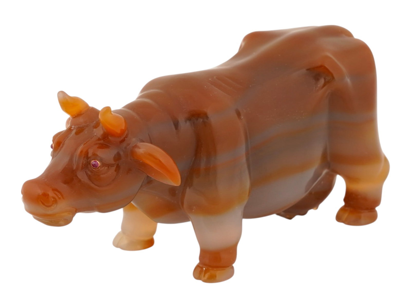 RUSSIAN CARVED AGATE COW FIGURINE W GOLD AND RUBY EYES: A Russian naturalistically hand carved honey Agate figurine. The figurine is made in the shape of a cow. The figurine is encrusted with Ruby stone eyes in Gold settings. Russian Hand Carved Natural