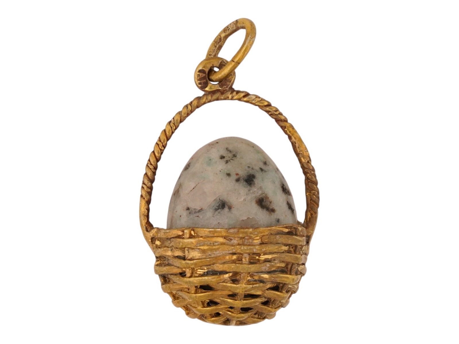 RUSSIAN SILVER DALMATIAN BASKET EASTER EGG PENDANT: A Russian 84 gilt silver and hand carved dalmatian stone Easter egg in a woven basket pendant. Marked with an 84 Russian silver standard hallmark and the makers mark on a fitting ring. Russian Silver