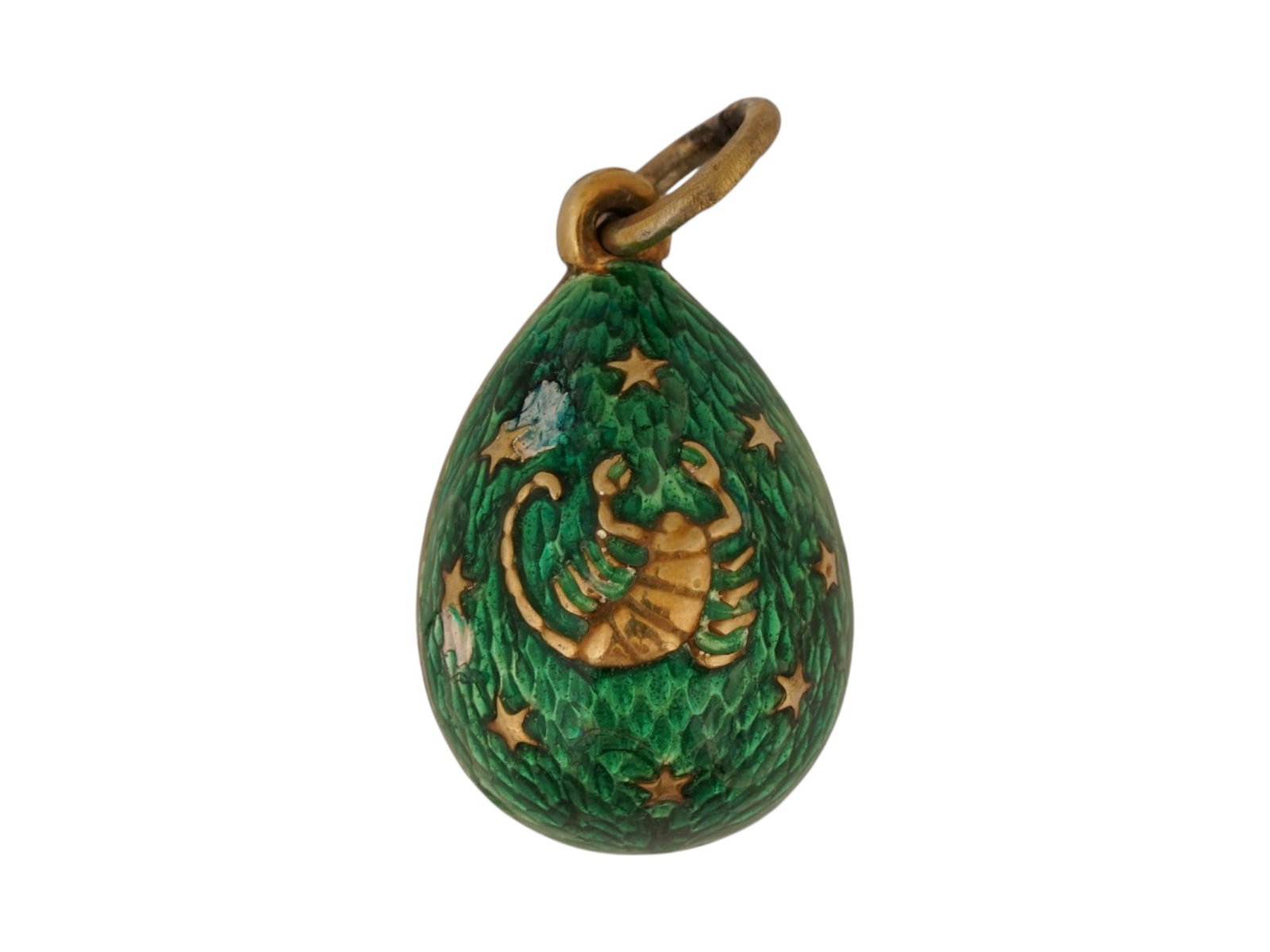 RUSSIAN GILT SILVER ENAMEL SCORPIO EGG PENDANT: A Russian gilt silver enamel Easter egg pendant. The egg pendant, consisting of two parts, is adorned with green guilloche enamel, creating an exquisite and vibrant design. The recto side features a