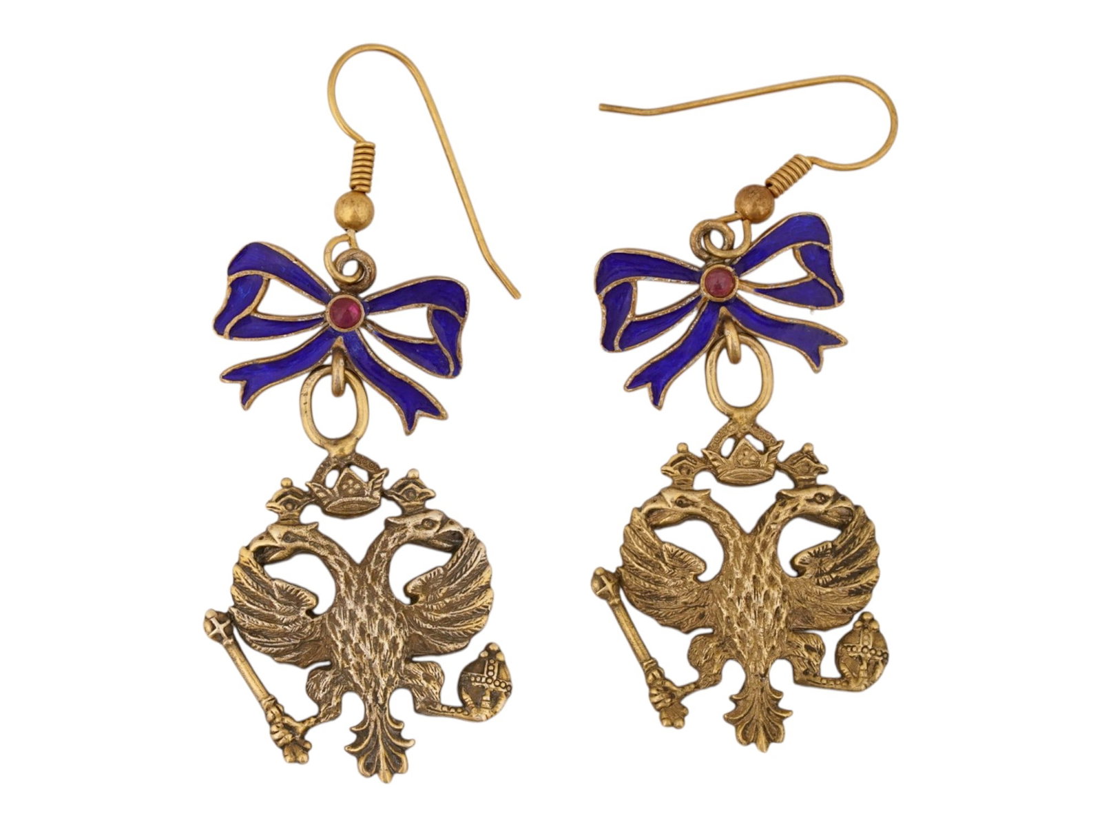 RUSSIAN GILT SILVER ENAMEL IMPERIAL EAGLE EARRINGS: A pair of Russian gilt silver dangle earrings representing the double-headed Imperial Eagle. The eagles are topped with enamelled blue ribbons that are inset with central ruby cabochons. Fish hook