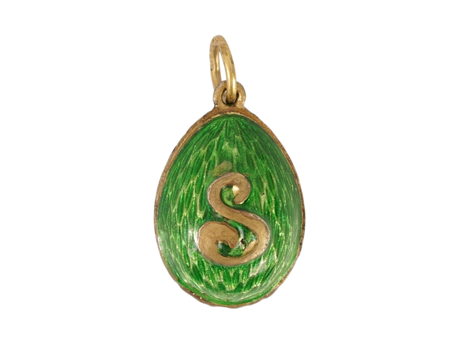 RUSSIAN SILVER GUILLOCHE ENAMEL EASTER EGG PENDANT: A Russian gilt silver Easter Egg pendant with green guilloche enamel surface. Letter S motif on the obverse. Hallmark of 88 silver standard and makers mark are on the fitting ring. Total Weight: 7 g.