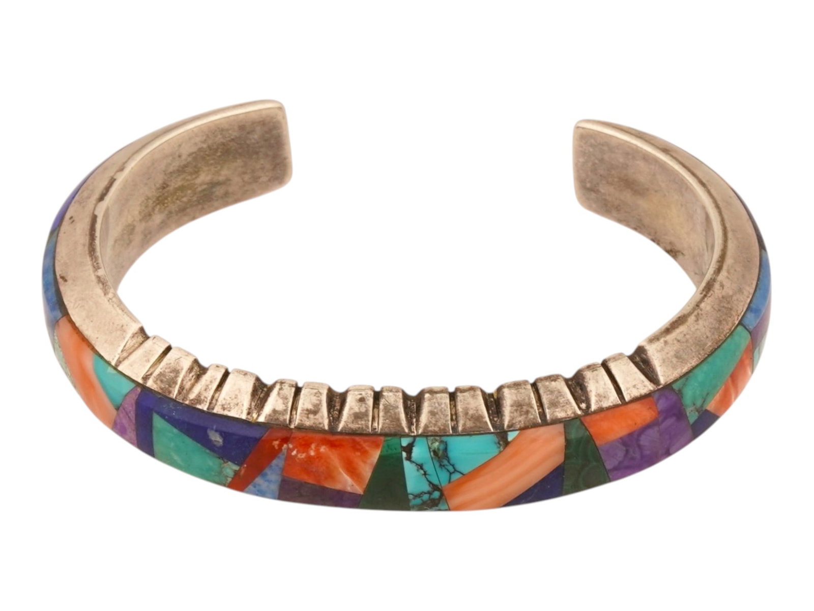 AMERICAN YELLOW HORSE SILVER BRACELET W GEMSTONES: An American heavy gauge sterling silver cuff bracelet, a signature work from the Yellowhorse family, featuring a vibrant multi stone mosaic inlay along the outer perimeter. The stones include various