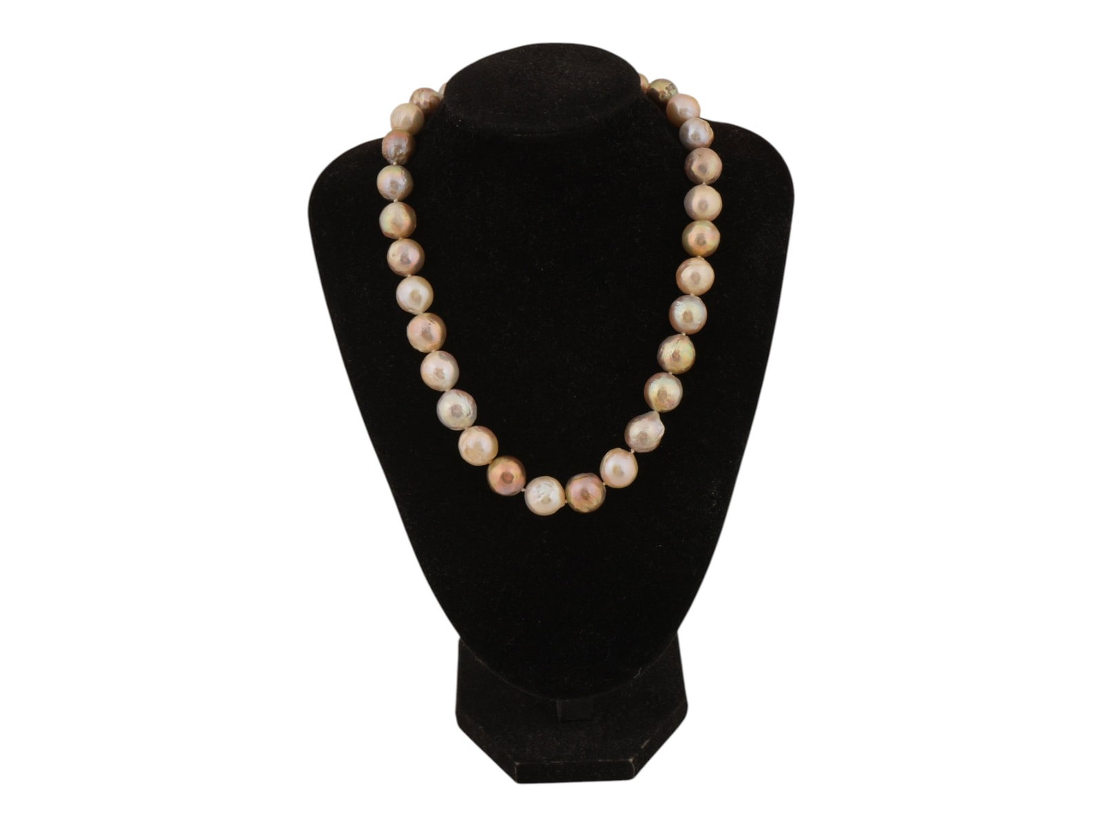 NATURAL BAROQUE PEARL NECKLACE W POSSIBLY SILVER CLASP: A natural Baroque sea pearl necklace. The necklace features large, irregularly shaped beads in a warm palette of shades, from cream to yellow and peach. Possibly silver clasp. Statement Elegant