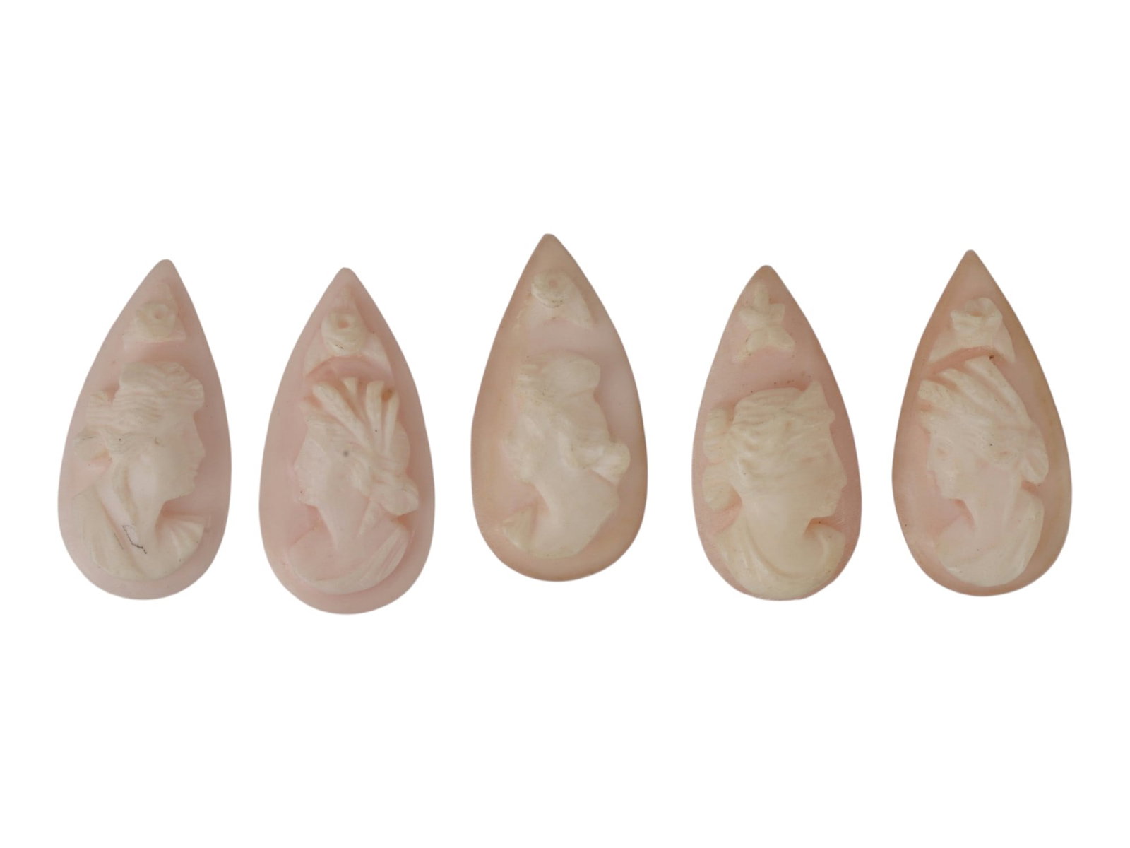 LOT OF FEMALE PORTRAIT CARVED PINK CORAL CAMEOS: A lot of five hand carved pink coral cameos. Each piece depicts a female profile portrait or nymph rendered in high relief. Marquise shape. Collectible Jewelry And Glyptic Art, Sculpture. THIS LOT IS 