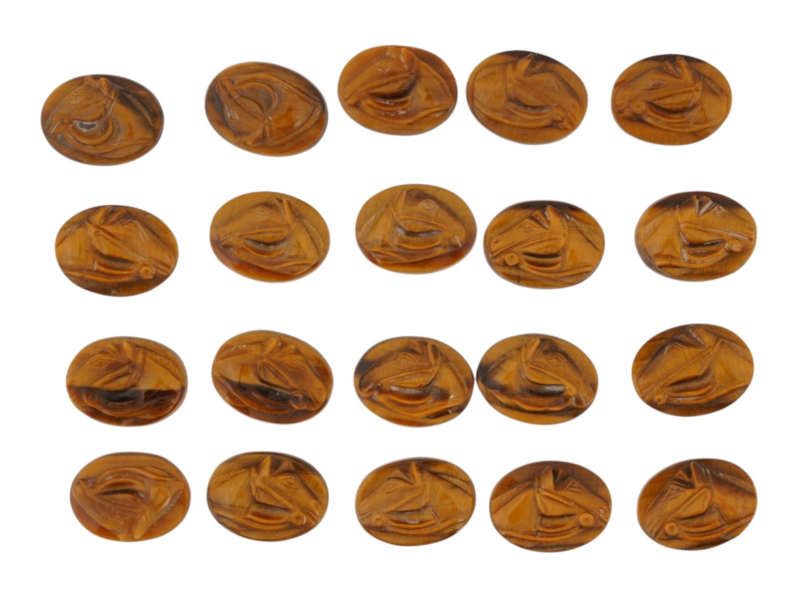COLLECTION OF CARVED TIGERS EYE HORSE CAMEOS: A lot of 20 hand carved tigers eye cameos. Each piece features a horse head rendered in high relief. Oval shape. Collectible Jewelry And Glyptic Art, Sculpture, Mineral Stones. THIS LOT IS ELIGIBLE FO