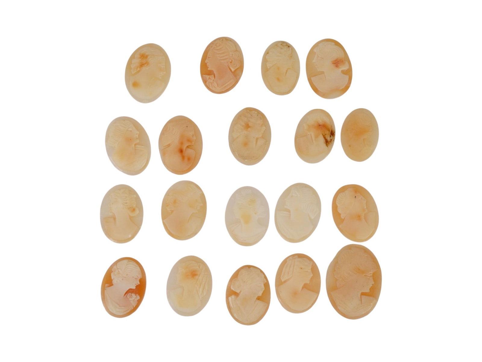 COLLECTION OF HAND CARVED SHELL CAMEO MEDALLIONS: A collection of vintage hand carved cameo medallions. A total of 19 items. Each piece is crafted from conch shell featuring a female portrait in the Victorian manner rendered in high relief. The cameo