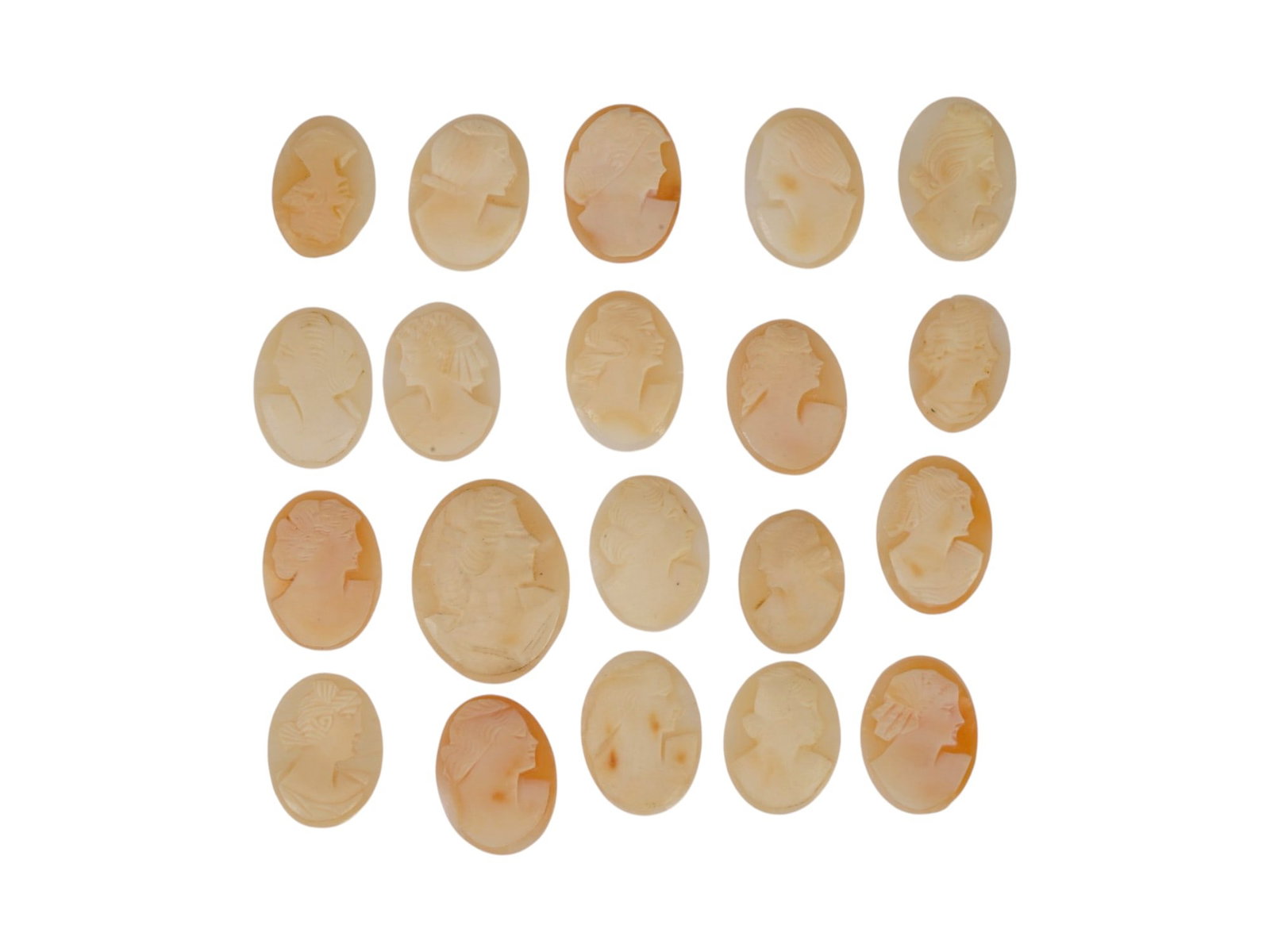 COLLECTION OF HAND CARVED SHELL CAMEO MEDALLIONS: A collection of vintage hand carved cameo medallions. A total of 20 items. Each piece is crafted from conch shell featuring a female portrait in the Victorian manner rendered in high relief. The cameo