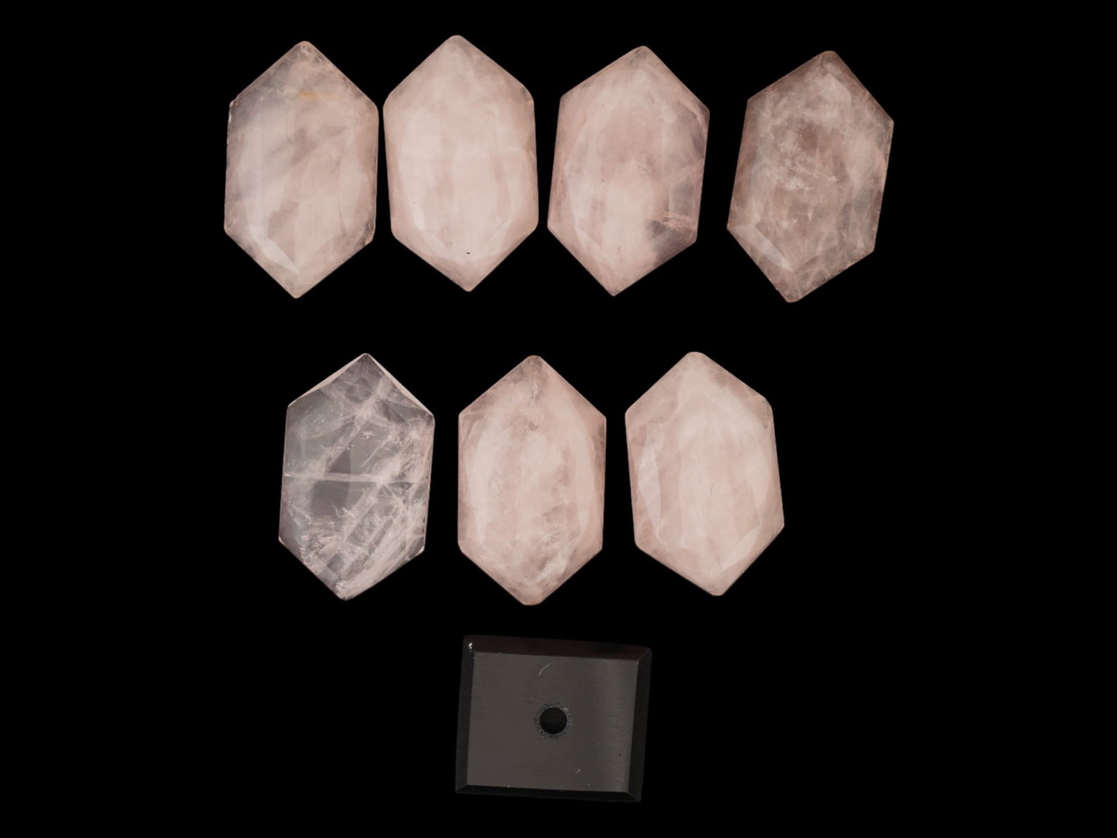LOT OF 7 CARVED ROSE QUARTZ STONES: A lot of 7 carved rose quartz stones. Hexagonal shape, polished surface. The lot also includes a clear glass bead. Gemstone Jewelry, Loose Natural Mineral Stones. THIS LOT IS ELIGIBLE FOR A 30-DAY UNC
