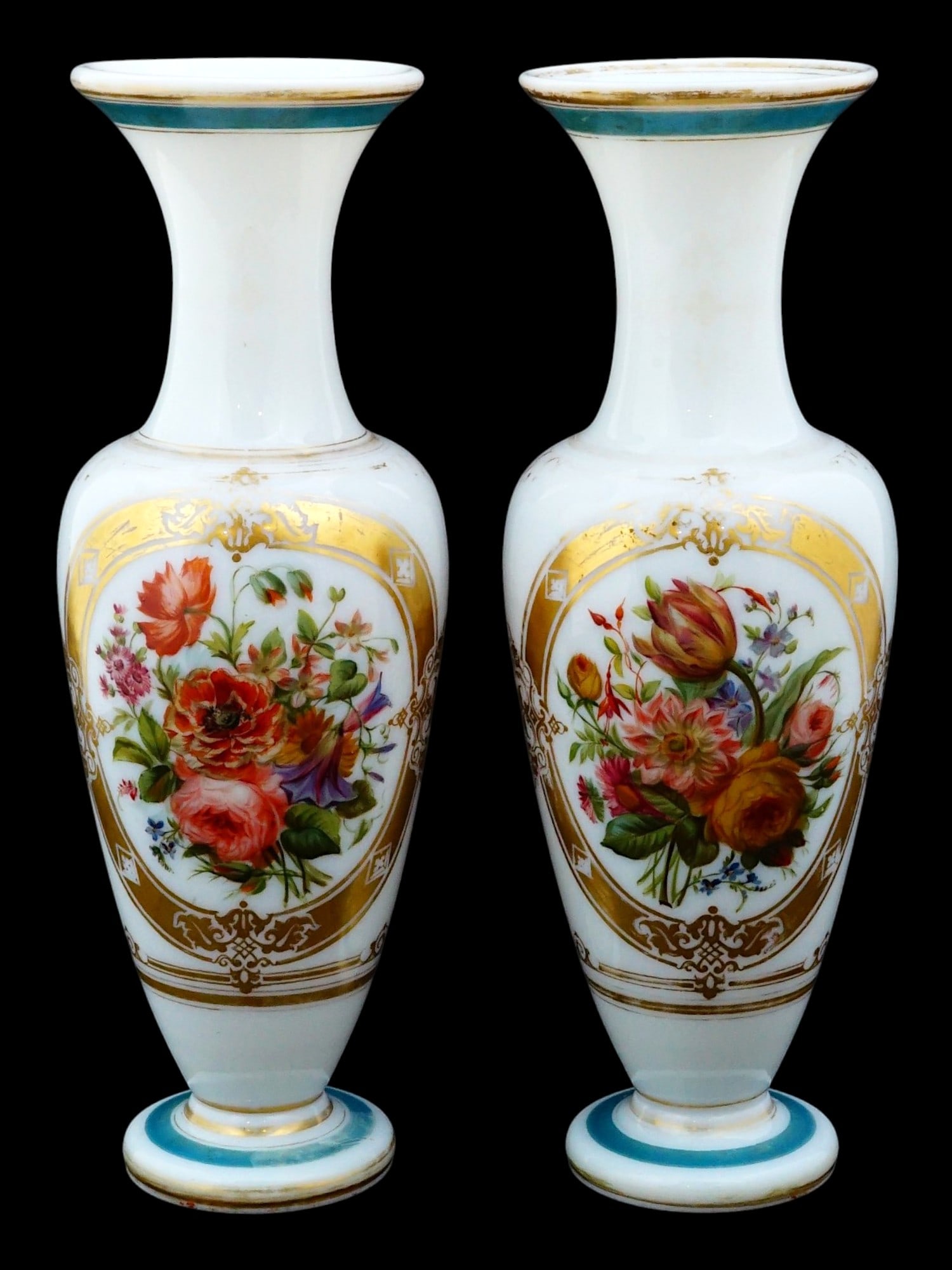 PAIR OF FRENCH OPALINE GLASS VASES ATTR TO BACCARAT: A pair of French opaline glass vases, attributed to Baccarat. Each vase features a milky white body of baluster form with a flared neck and circular foot. Each vessel is hand painted with a central po