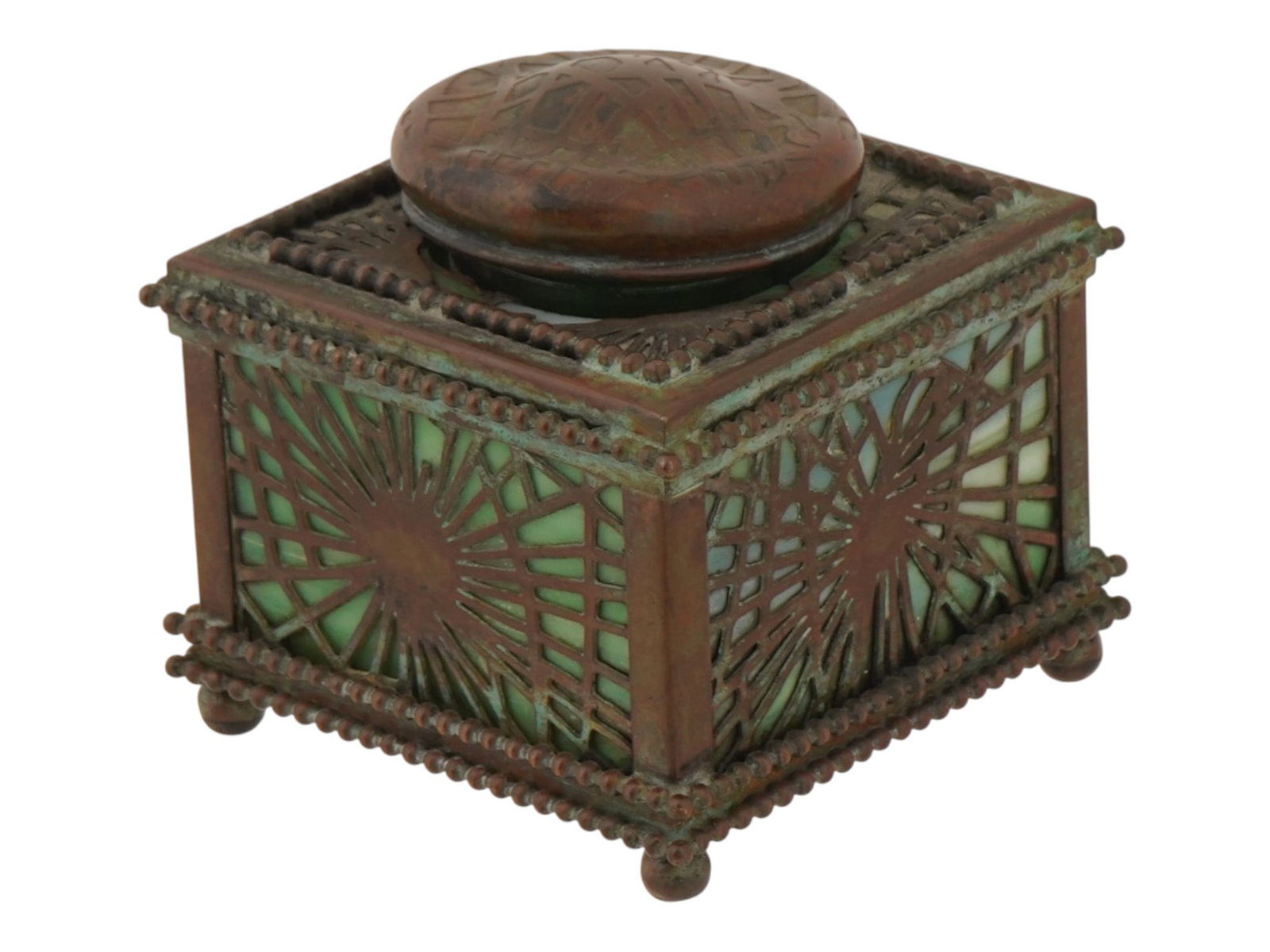 TIFFANY STUDIOS GLASS AND BRONZE PINE NEEDLE INKWELL: An antique bronze and green glass inkwell by Tiffany Studios. Ca. 1910s. Pine Needle design. Footed square piece with a hinged lid. Clear glass inset. Marked Tiffany Studios, New York, 845 on the bott