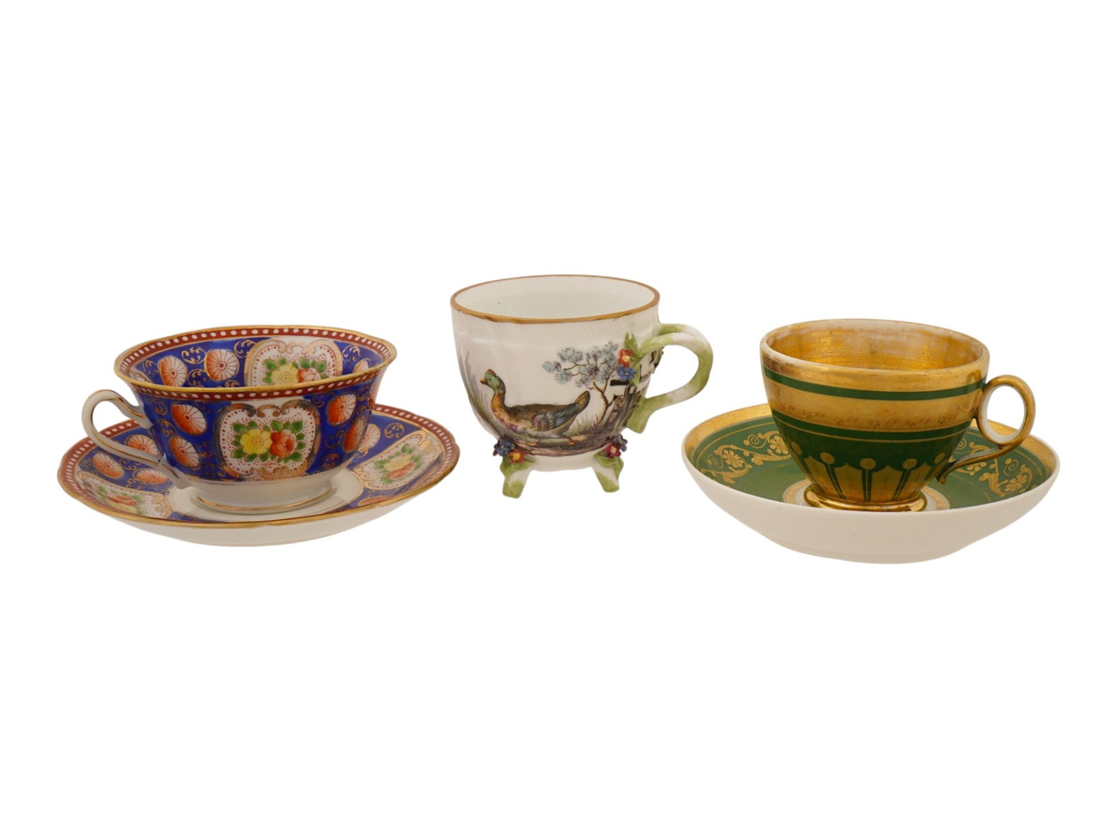 VINTAGE EUROPEAN PORCELAIN TEA CUPS AND SAUCERS: A lot of three vintage European porcelain tea cups and saucers. The lot includes an antique Imari-style cup and saucer decorated with flower motifs, presumably by Royal Albert Crown China, a German fo