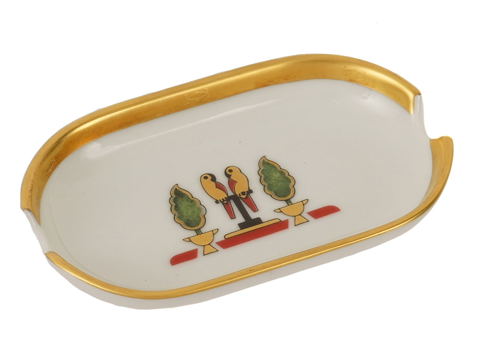 FRENCH CARTIER LA MAISON DE LOUIS PORCELAIN ASHTRAY: A vintage French Cartier Limoges porcelain ashtray from the limited edition La Maison de Louis collection. Circa the late 20th century, 1980s. The oval ashtray is decorated with a vibrant stylized par