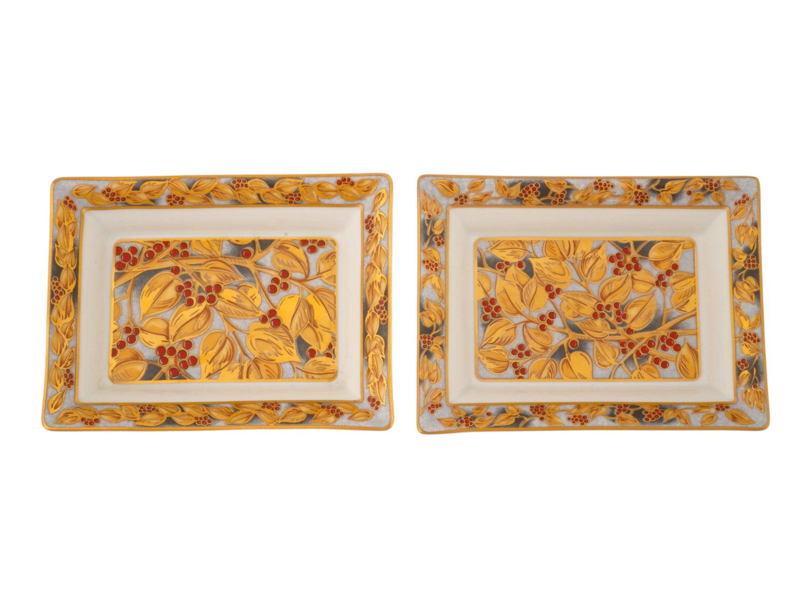 PAIR OF PATEK PHILIPPE PORCELAIN DISHES VIDE POCHE: A pair of collectible Patek Philippe porcelain dishes vide-poche from the 2002 collection, made in France by Limoges. Each item features a botanical motif of yellow gold leaves and red berries, set ag