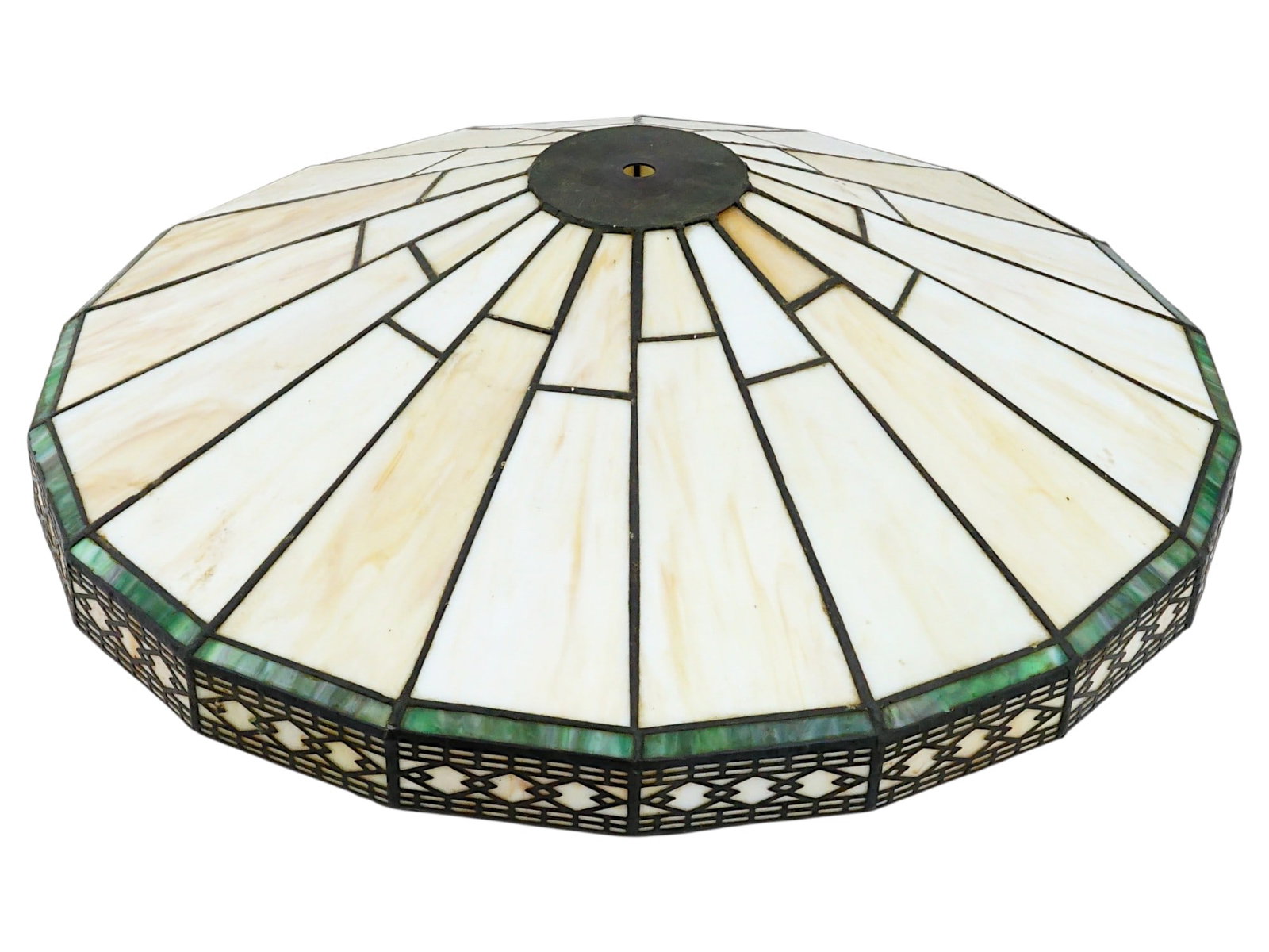 VINTAGE AMERICAN STAINED GLASS LAMP SHADE: A vintage American Arts and Crafts style stained glass lamp shade. Circa the 20th century. The primary body of the shade features segments of creamy white or beige glass arranged in a radiating