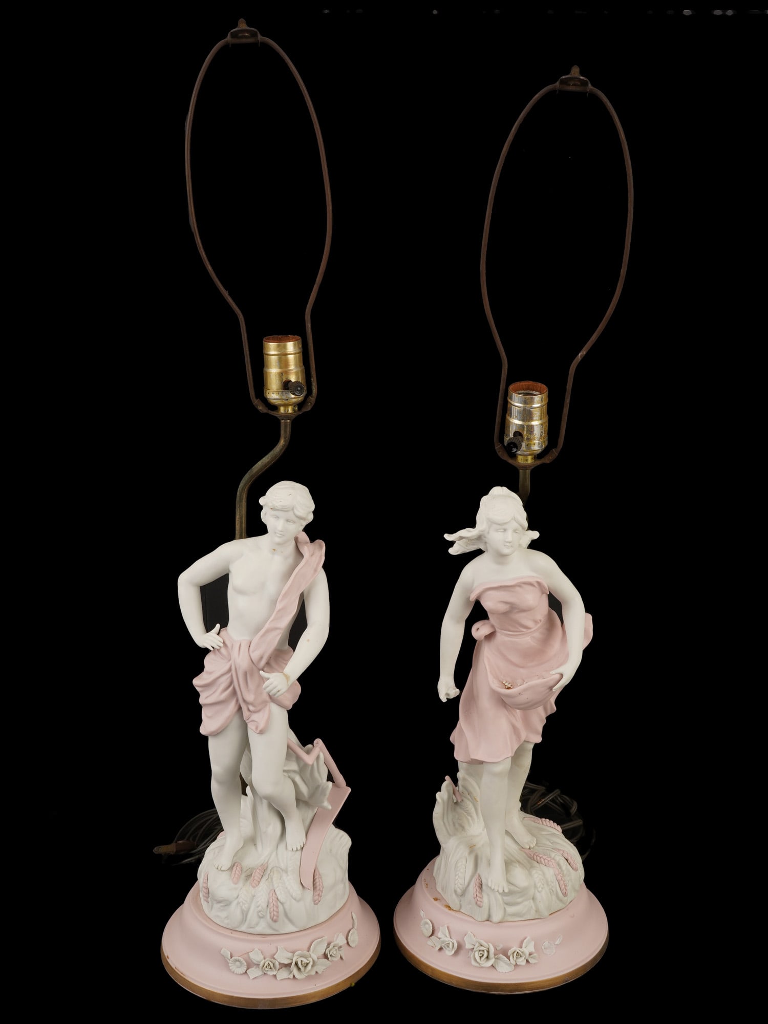 VINTAGE TABLE LAMPS W BISQUE PORCELAIN FIGURINES: A pair of vintage table lamps with glazed bisque porcelain figurines in the Neo-Rococo style. The figurines of the lamp represent a young man and woman painted in soft pink tones and accented with