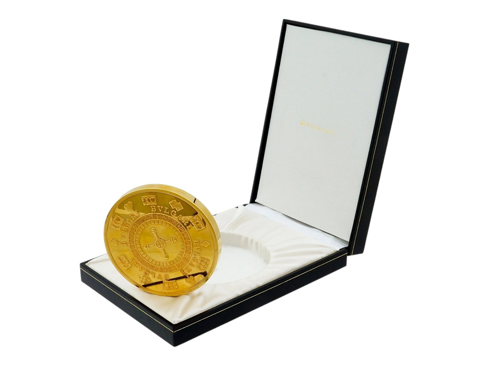 SILVER GILT BULGARI PAPER WEIGHT LAS VEGAS CASINO: A vintage Bulgari gilt sterling silver oversized Vegas Casino paper weight coin in a fitted case. Designed with relief images of a roulette wheel and Las Vegas dice. Hallmarked with a 925 sterling sil