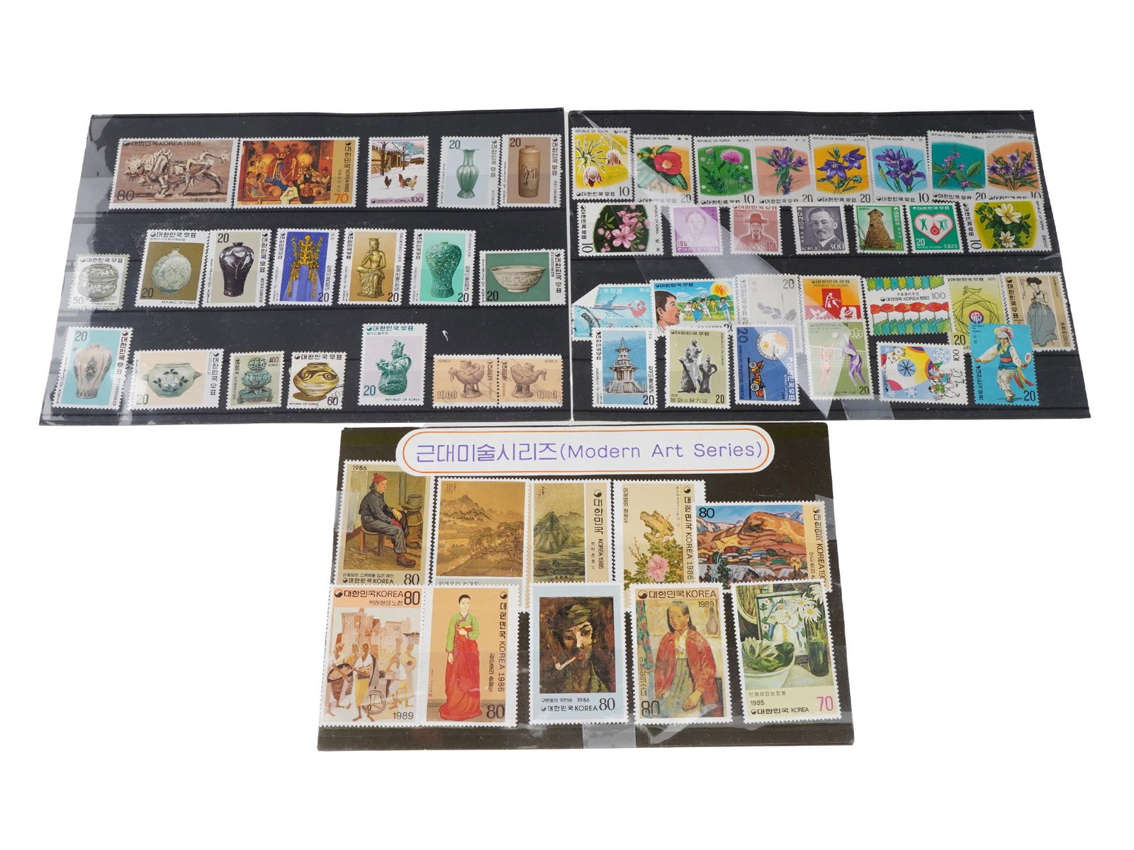 COLLECTION OF KOREAN ART NATIONAL TREASURES STAMPS: A collection of vintage Korean stamps. The collection includes 1980s Modern Art series and a variety of stamps illustrate floral arrangements and natural scenes. The lot also includes Korean National 