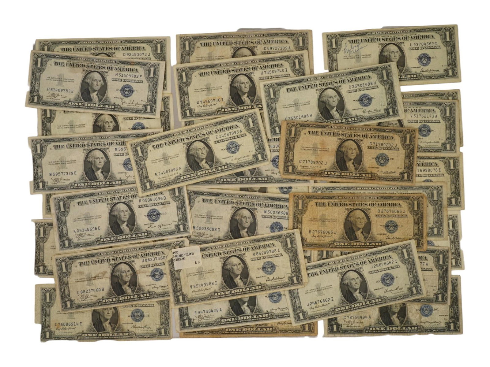 COLLECTION OF AMERICAN ONE DOLLAR SILVER CERTIFICATES: A large collection of antique mixed US banknotes, One Dollar silver certificates. Each banknote features a bust of George Washington. Silver certificates are a type of American representative money is