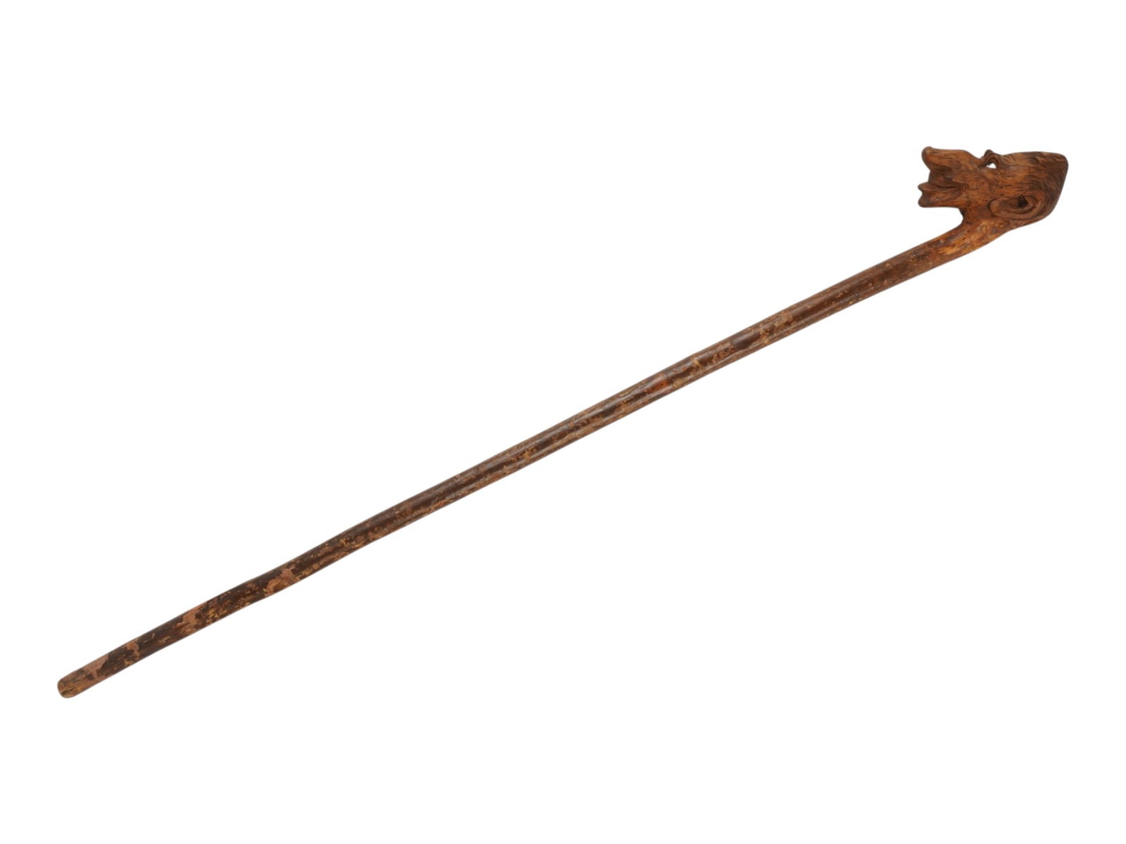 ANTIQUE FOLK ART WALKING STICK HAND CARVED FROM WOOD: An antique folk art walking stick hand-carved from natural wood. The root-form handle is carved with an expressive face, while the shaft retains its natural shape and texture. Antique Walking Canes An