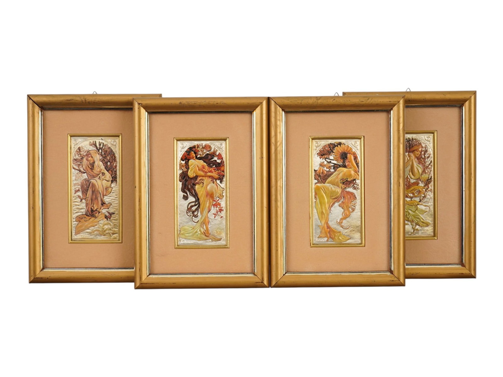 SET OF 4 PRINTS ON SILVER PLAQUES AFTER ALPHONSE MUCHA: A set of four prints on bas relief plaques, crafted from 925 sterling silver. Each features a polychrome depiction of a female figure representing one of the four seasons: Spring, Summer, Autumn, and 