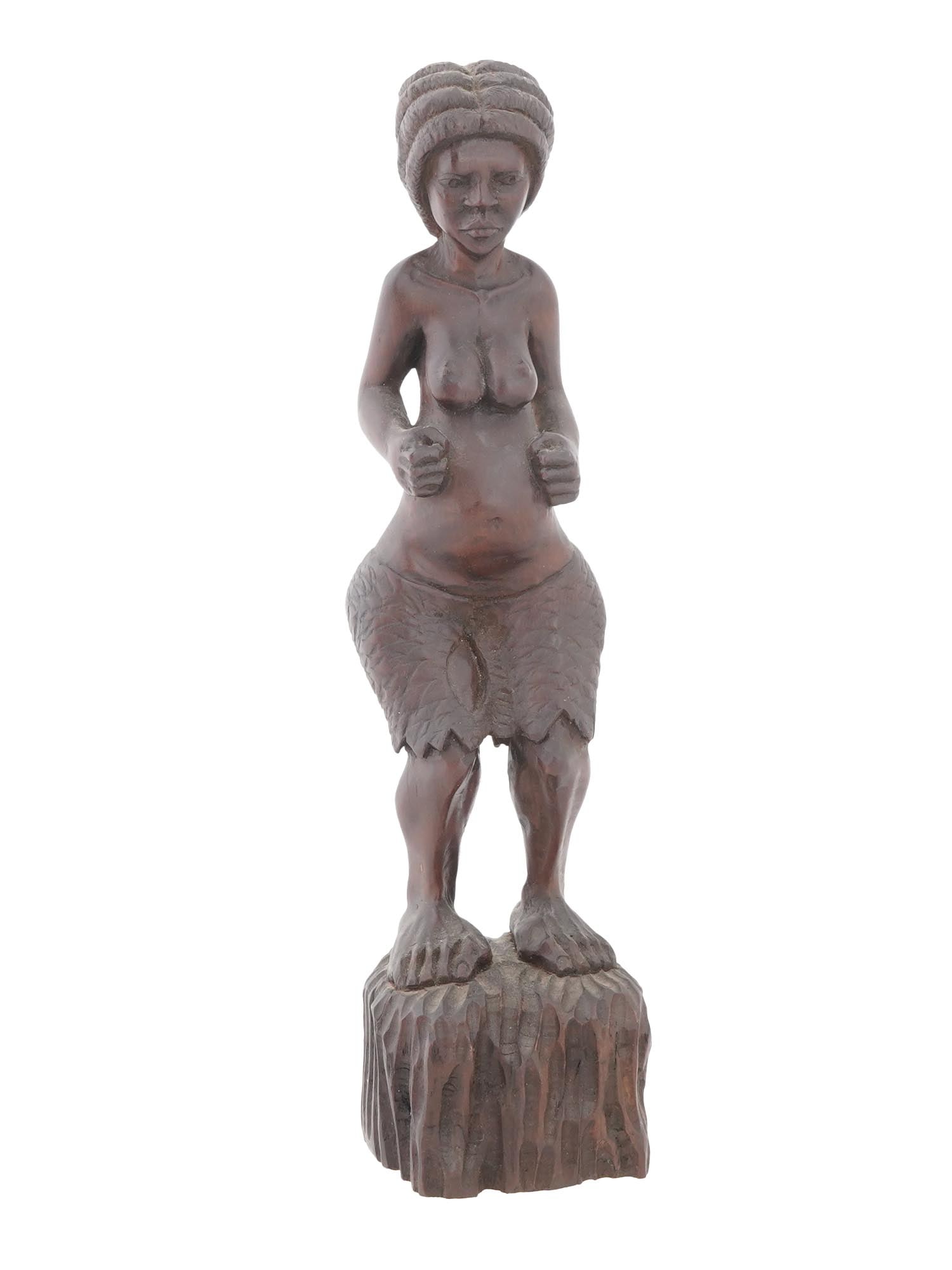 AFRICAN HAND CARVED RED WOOD FIGURINE OF WOMAN: An African hand carved redwood figurine. The figurine depicts a semi nude woman with bent arms and legs, probably a fertile figure. The figure is adorned with a traditional hairstyle. Mounted on a