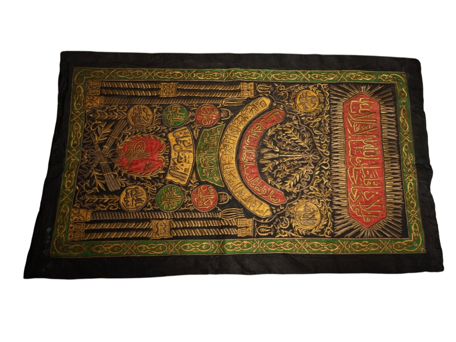 ISLAMIC OTTOMAN EMBROIDERED CALLIGRAPHIC TEXTILE PANEL: An Ottoman sitara, decorative cover or hanging, adorned with traditional calligraphy and metal thread embroidered panel. Such luxurious textiles were produced in the court workshops of the Ottoman Emp