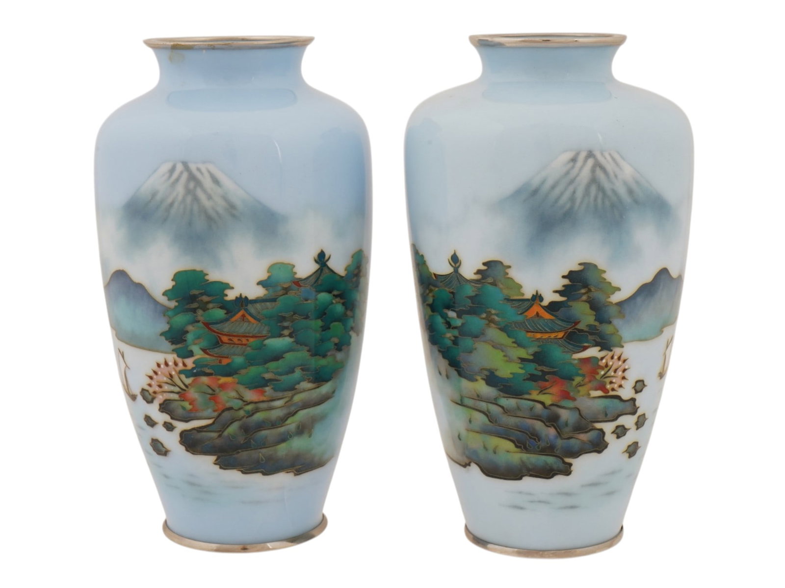 VINTAGE JAPANESE CLOISONNE ENAMEL MOUNT FUJI VASES: A pair of vintage Japanese cloisonne enamel vases dating to the mid 20th century, featuring a pale blue ground decorated with a scenic landscape of Mount Fuji, misty hills, traditional temples, and pi