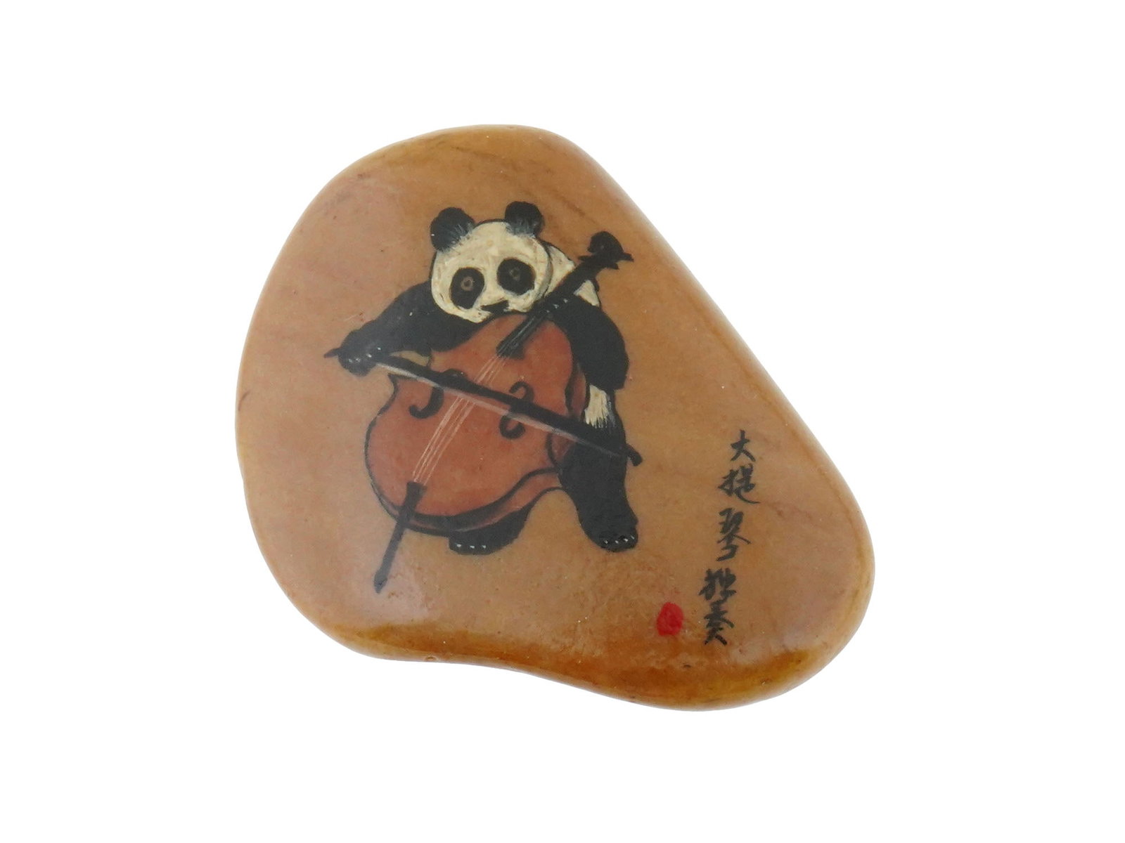 VINTAGE CHINESE SOUVENIR PAINTED STONE IOB: A vintage Chinese souvenir painted stone in the original box. The irregularly shaped natural stone is painted with an image of a panda bear playing the cello. Marked in Chinese lower right and on the 