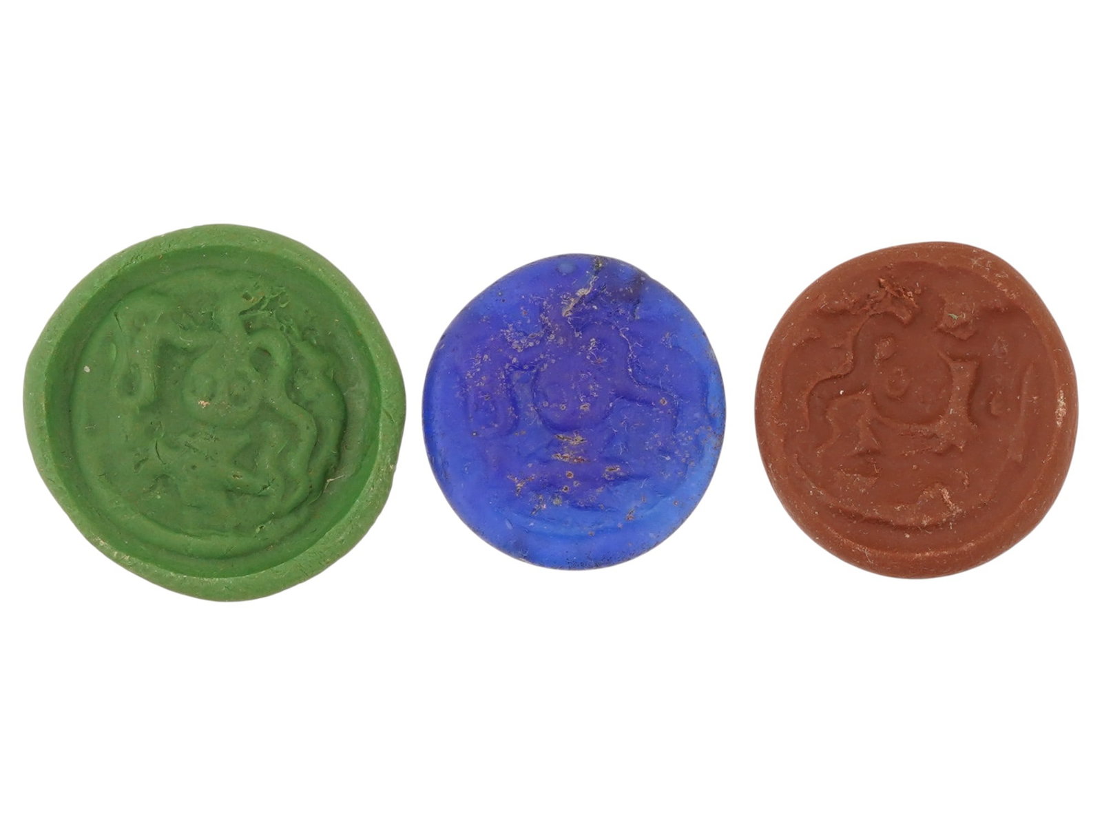 ANCIENT ROMAN MOLDED GLASS MEDALLIONS 100 TO 300 AD: A lot of three ancient Roman molded glass medallions un blue, green and brown shades. The wares depict an octopus design. Circa: 100 to 300 AD. Ancient Roman Jewelry, Archaeological Finds And Relics, 