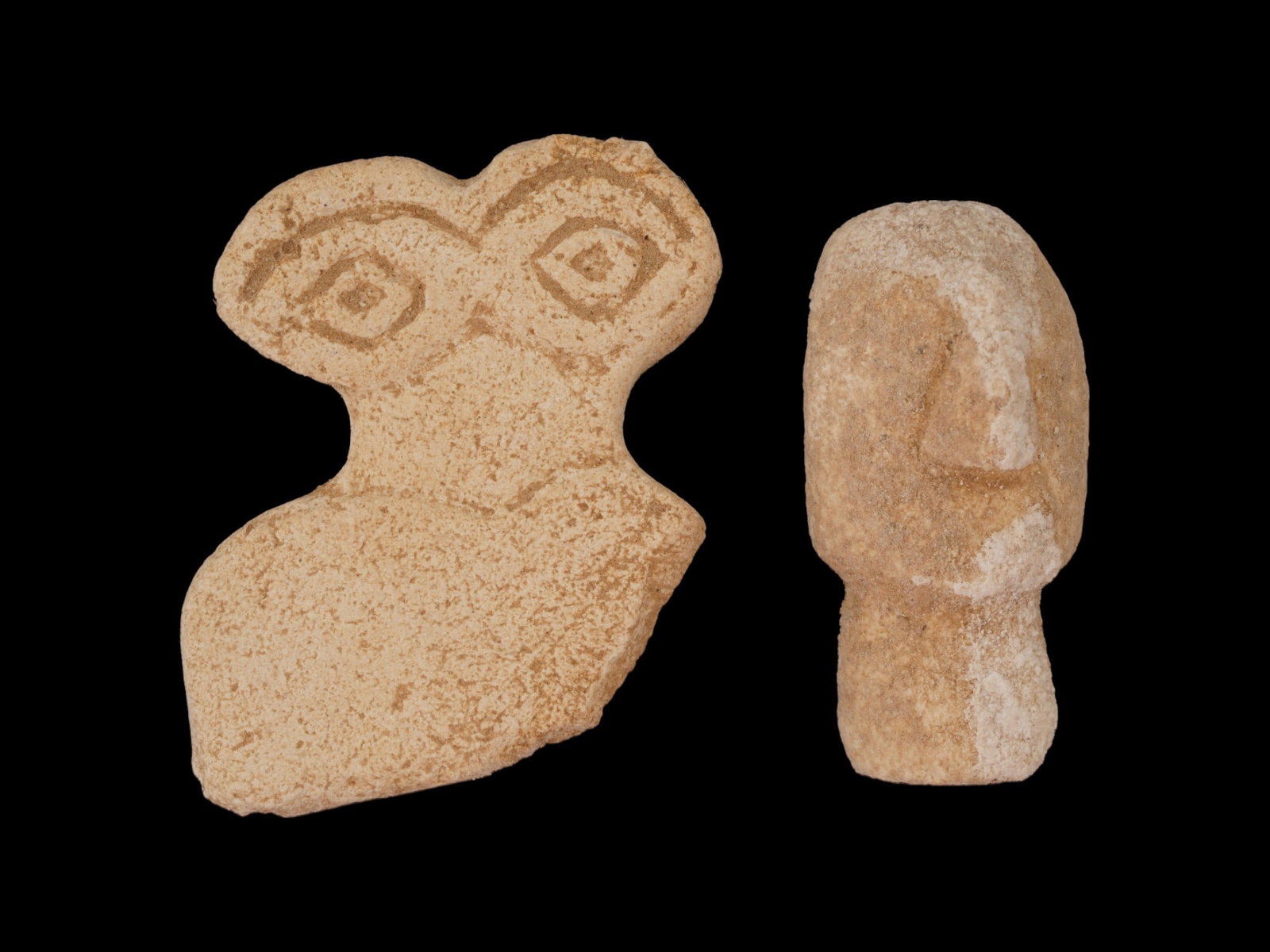 LOT OF ANCIENT WESTERN ASIAN CARVED EYE IDOL FRAGMENTS: A lot of two ancient Western Asian carved stone eye idol sculptural fragments. Shaped like a weight surmounted by two eyes, much scholarly design has been proposed about their meanings. These so calle