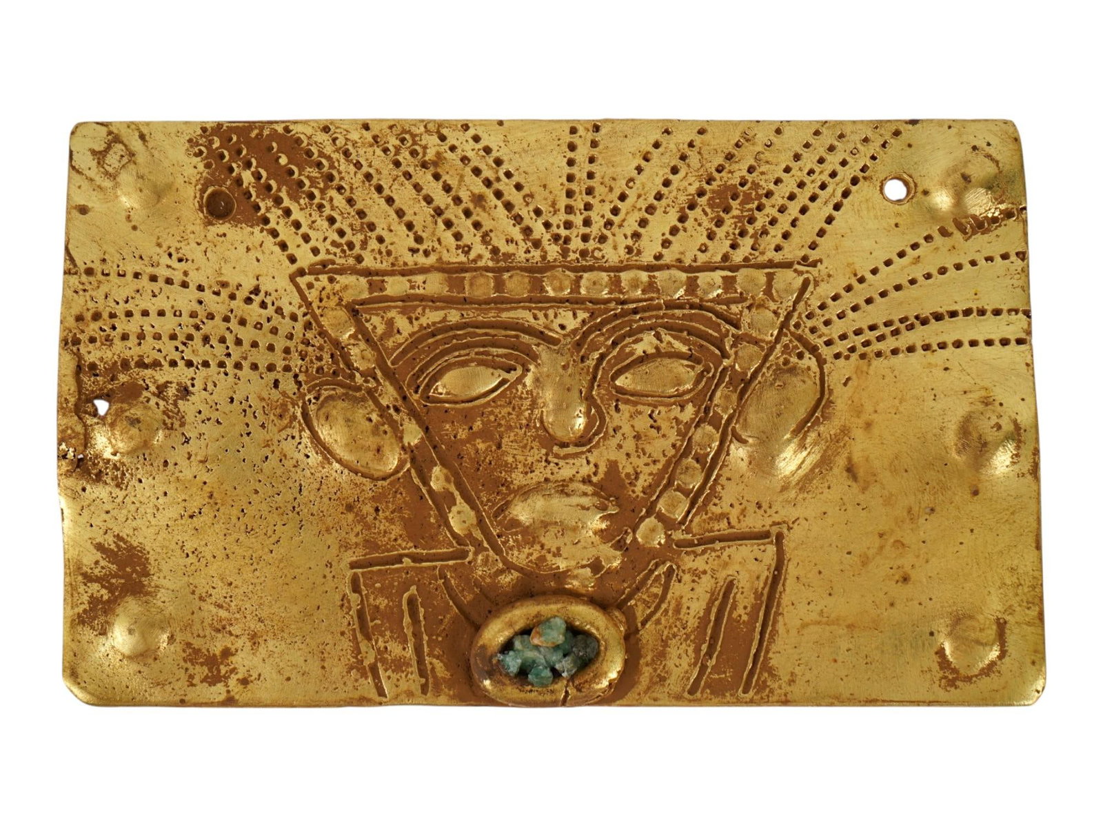 ANCIENT PRE COLUMBIAN TUMBAGA GOLD COPPER PLAQUE: An ancient Pre Columbian Tumbaga rectangular gold and copper alloy plaque, featuring a central repousse depiction of a masked deity or shamanic figure. The figure is rendered with a prominent radial h