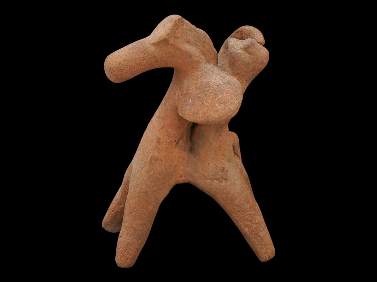 ANCIENT GREEK TERRACOTTA FIGURE OF A WARRIOR W A SHIELD: An ancient Greek terracotta figure, depicting a mounted warrior with a shield and dating approximately from 600 to 400 BC. Modeled in fired clay, the sculpture portrays a horseman in dynamic form, ref