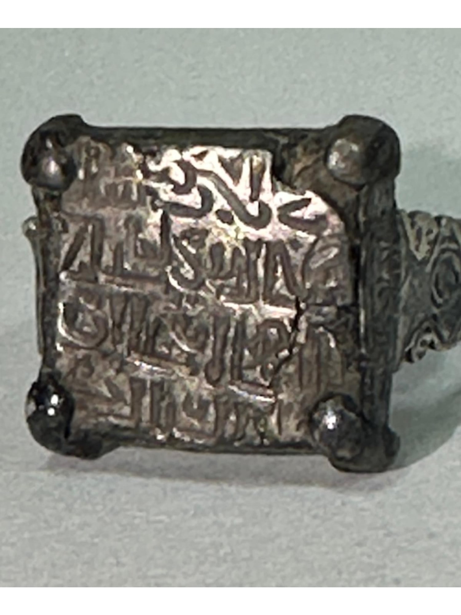 ANCIENT ISLAMIC SILVER RING W INSCRIPTION 600 TO 800 AD: An ancient Islamic silver signet ring, dating from 600 to 700 AD, from the time of the Prophet. The central part of the ring is decorated with an engraved Islamic inscription. Ancient Arabic Islamic R