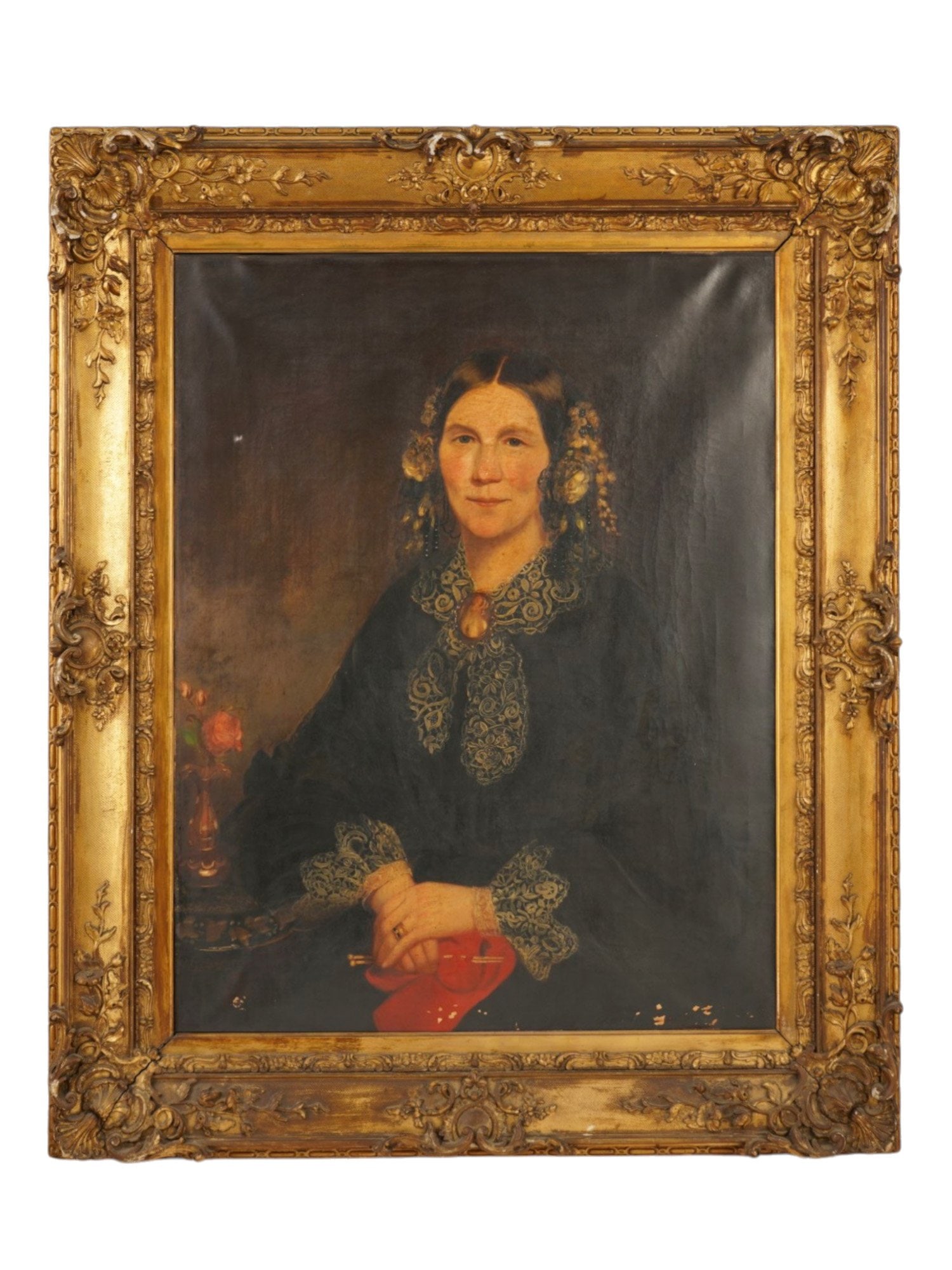 19TH CENTURY PORTRAIT OF WOMAN OIL PAINTING FRAMED: A 19th century oil painting on canvas depicting a portrait of a seated woman, dressed in a black gown featuring a prominent lace collar and matching cuffs. She is adorned with a central brooch and gol